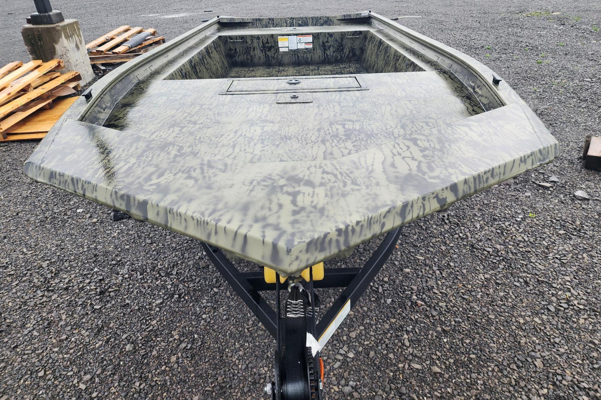 2026 Tracker Grizzly 1754 Utility boat with camouflage design on gravel surface.