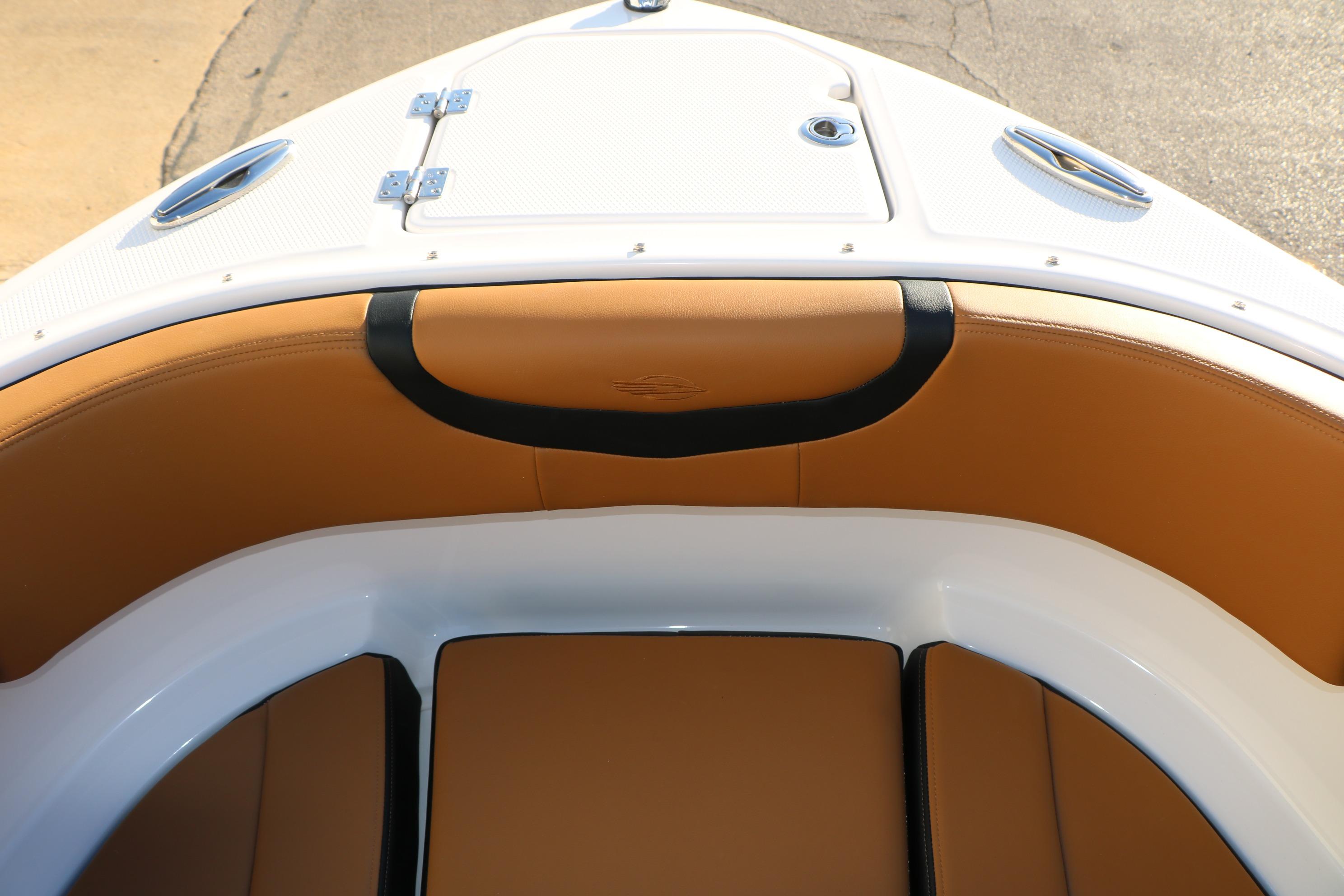 2026 Chaparral 247 SSX boat interior with tan leather seating and white accents.