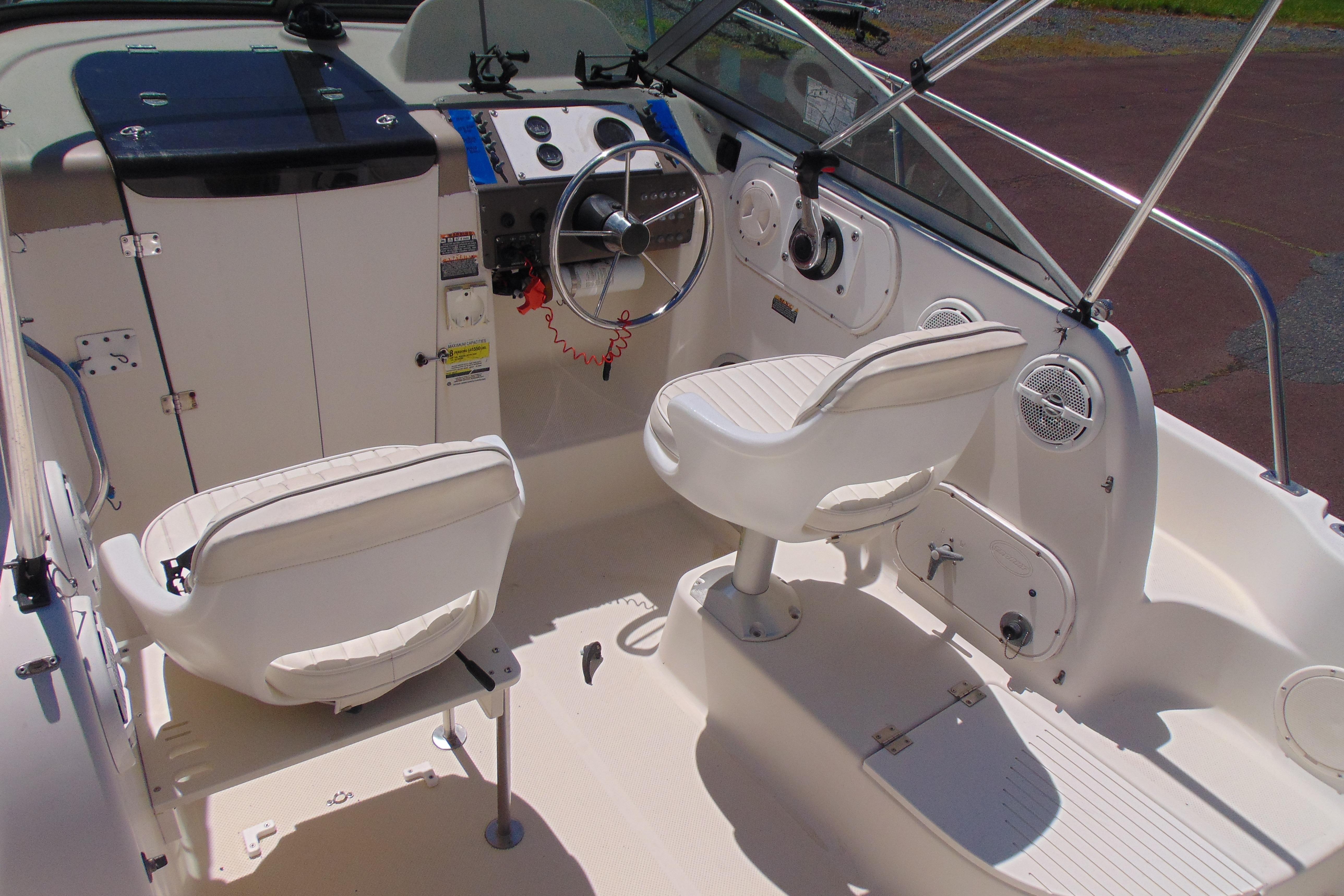 2002 Trophy Walkaround boat interior with steering wheel and seating.