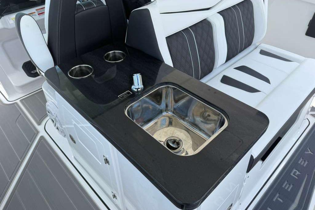 Luxury seating and sink area on 2026 Monterey Elite 30 OB boat.