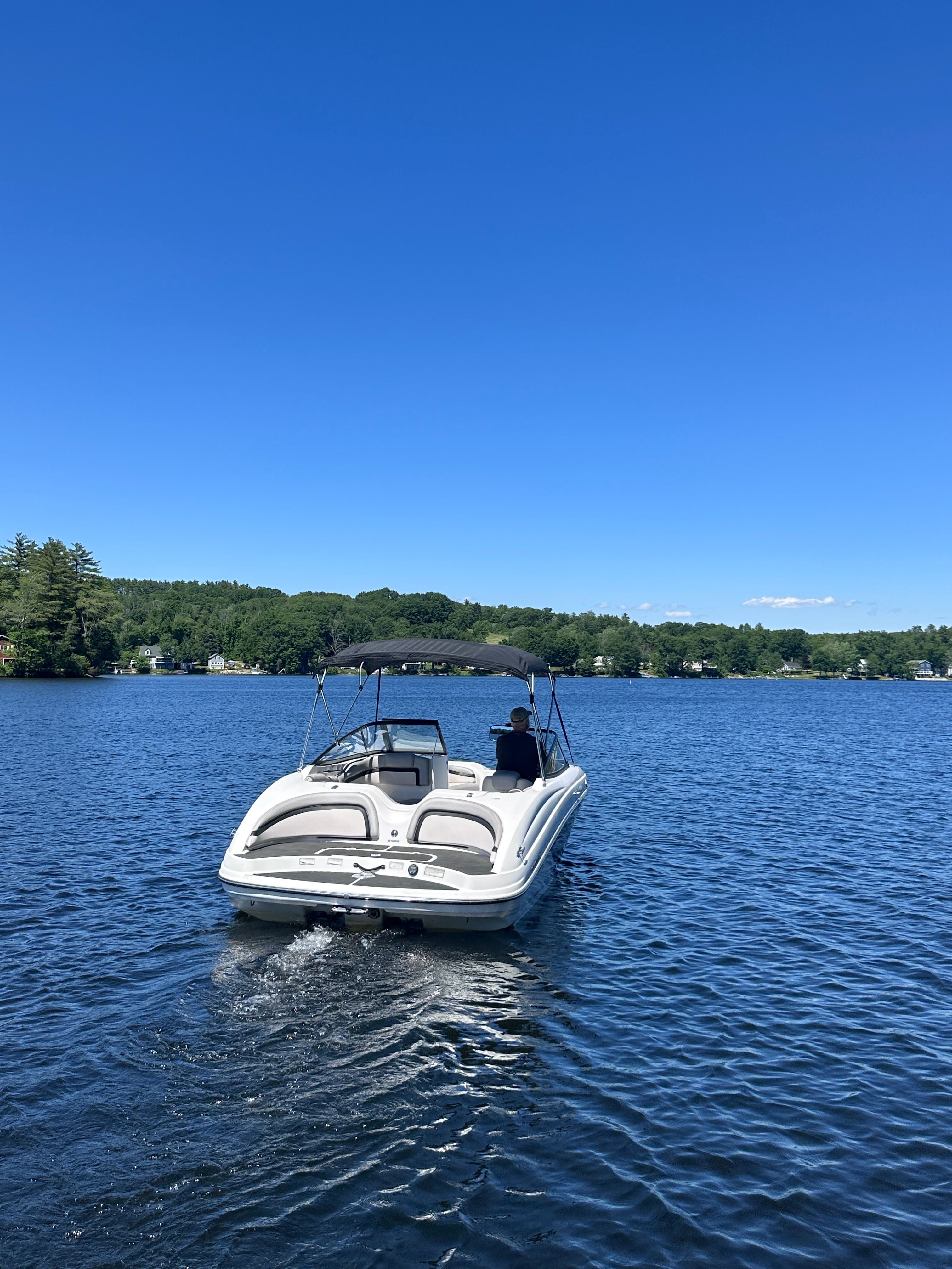 2010 Yamaha 212SS boat on a calm lake.