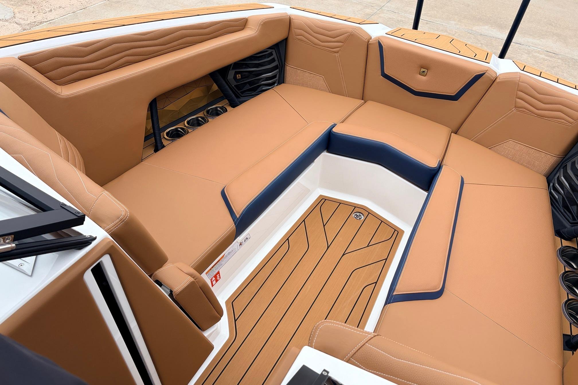 Luxurious interior of 2026 Nautique Super Air Nautique G25 boat with tan seating.