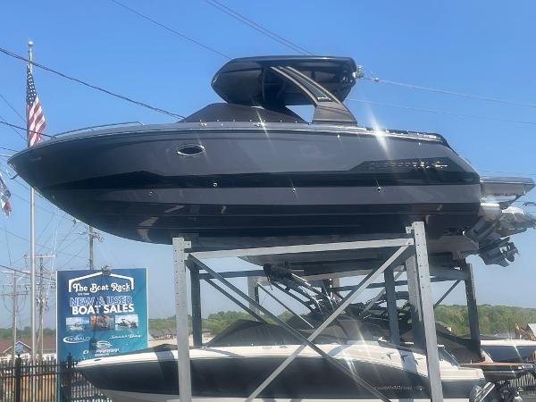 2025 Chaparral 2870 boat displayed at a dealership, elevated on a stand.