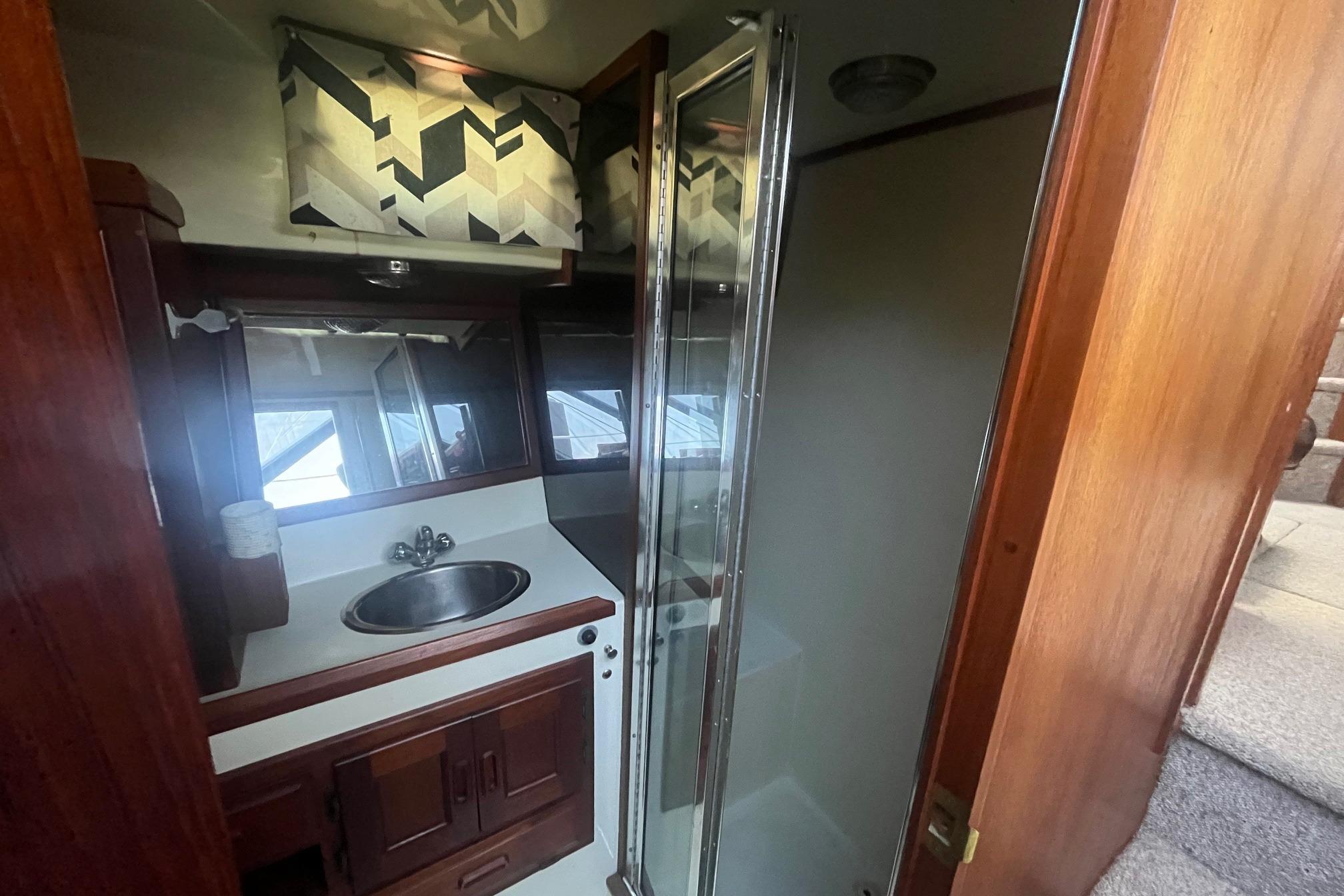 Bathroom interior of 1990 Cooper Prowler 35 yacht with sink and shower.