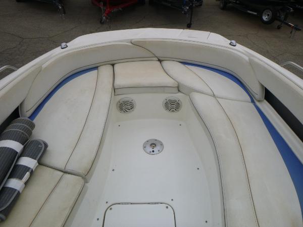 2007 Bayliner 197 Deck Boat interior seating area with white cushions and storage compartments.