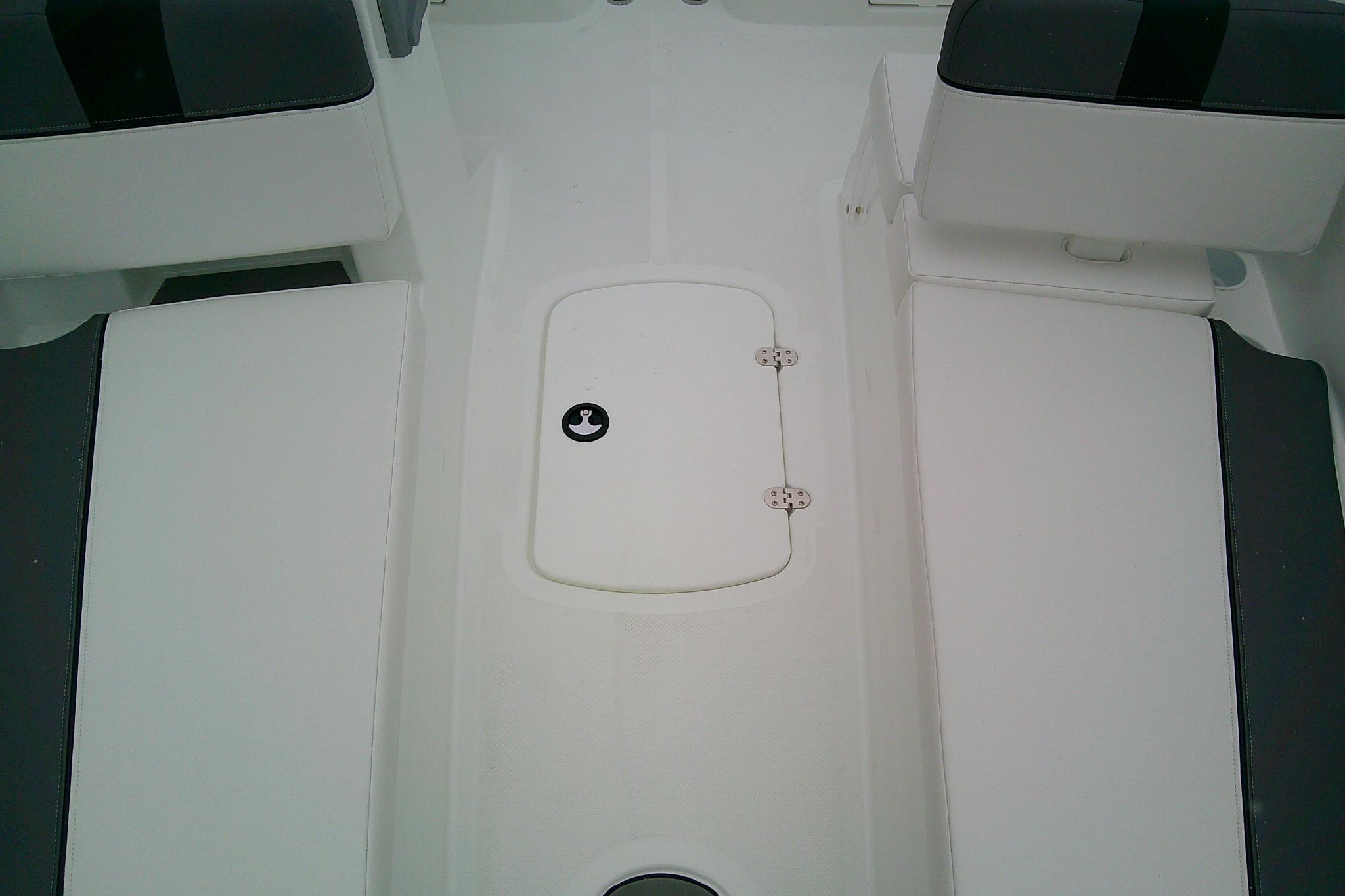 2026 Tahoe T18 boat interior with white seating and storage compartment.