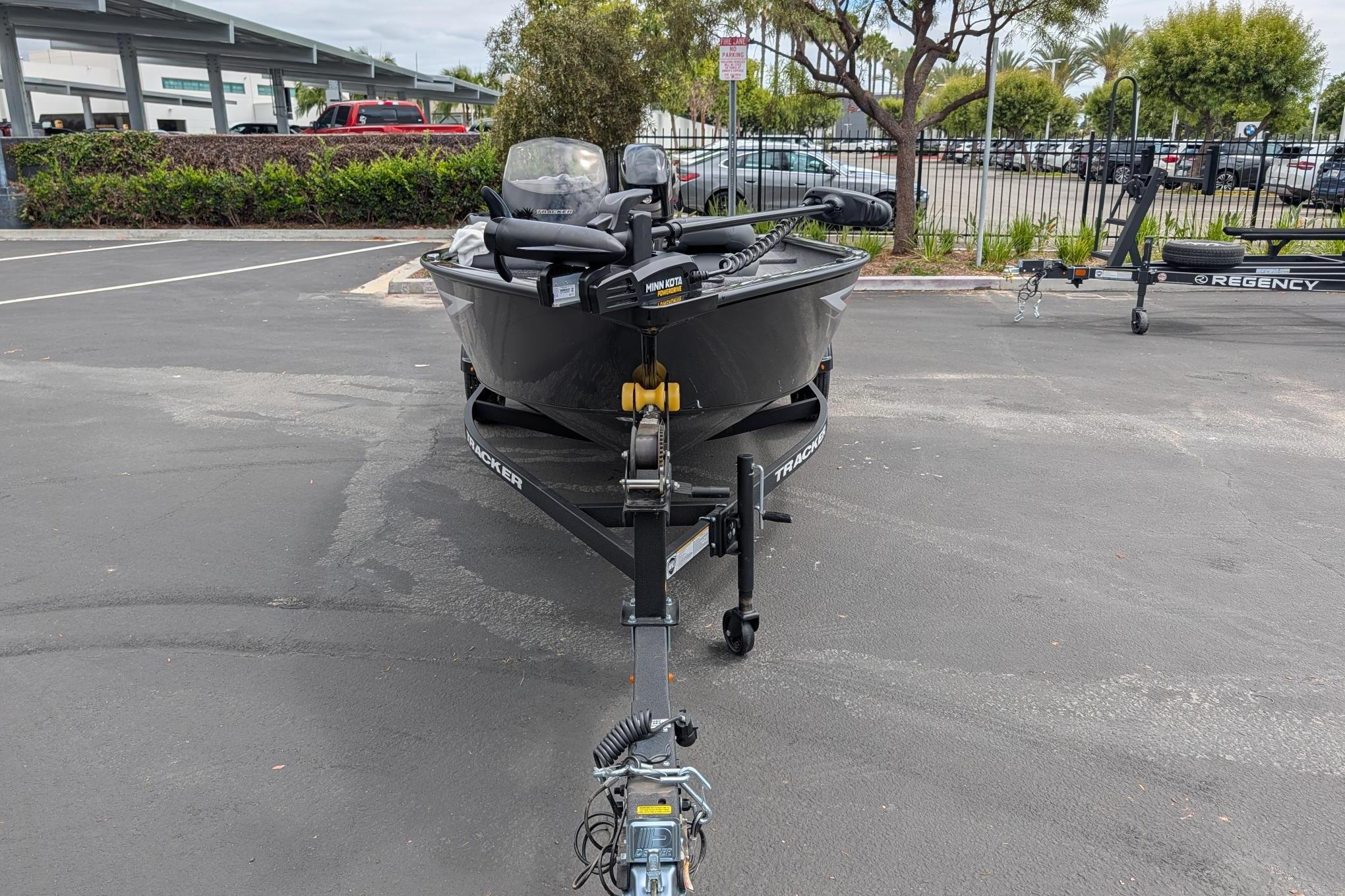 2026 Tracker Super Guide V-16 SC boat on trailer in parking lot.