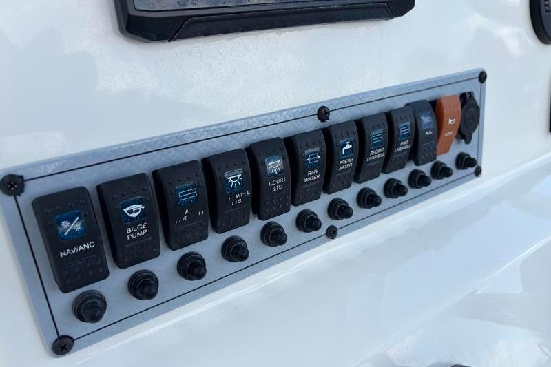 Control panel of 2025 Key West 210 Bay Reef boat with labeled switches.