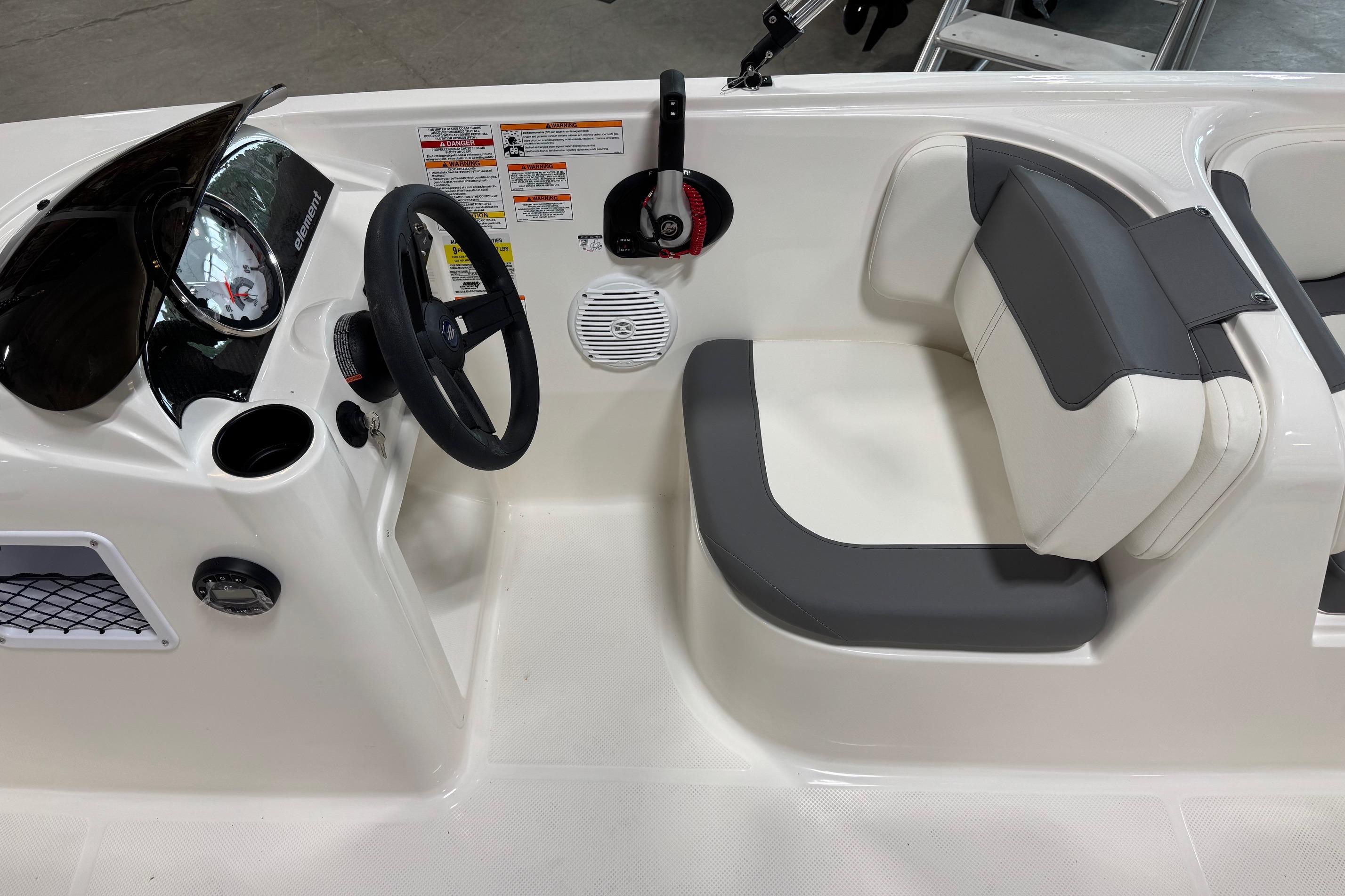 2026 Bayliner Element E18 boat interior with steering wheel and cushioned seating.