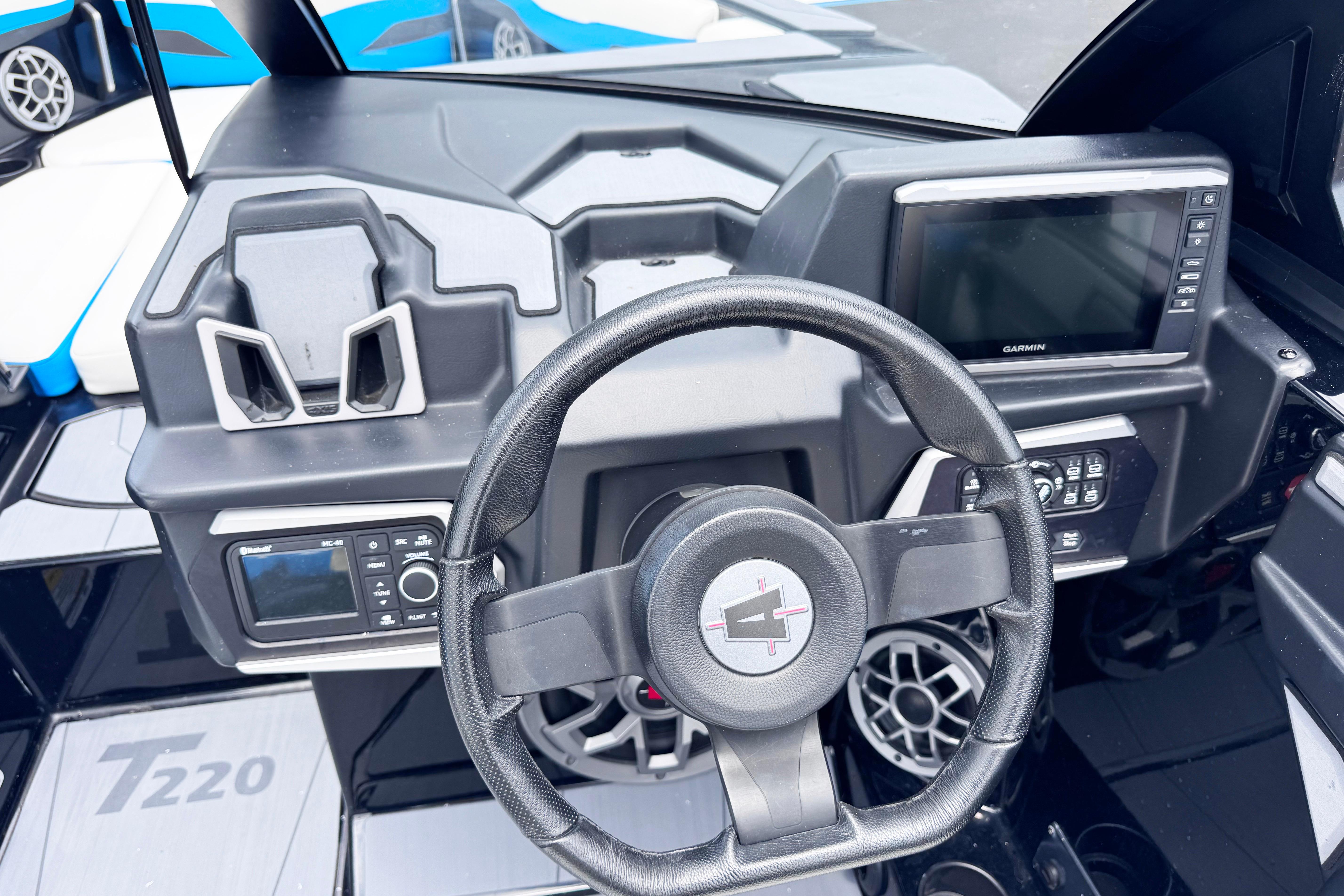 2022 Axis T220 boat dashboard with steering wheel and Garmin display.