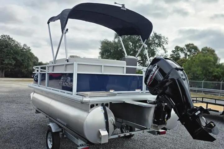 2026 Sun Tracker Bass Buggy 16 XL Select pontoon boat with Mercury outboard motor.