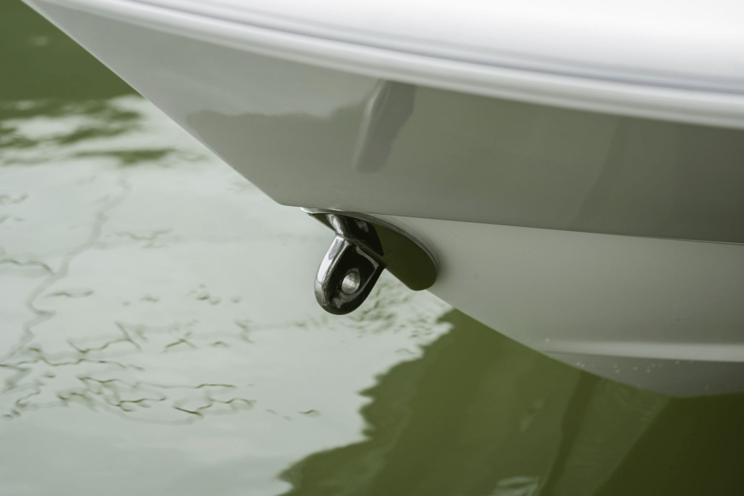 Close-up of the bow of a 2026 Boston Whaler 160 Super Sport, hovering over calm water.