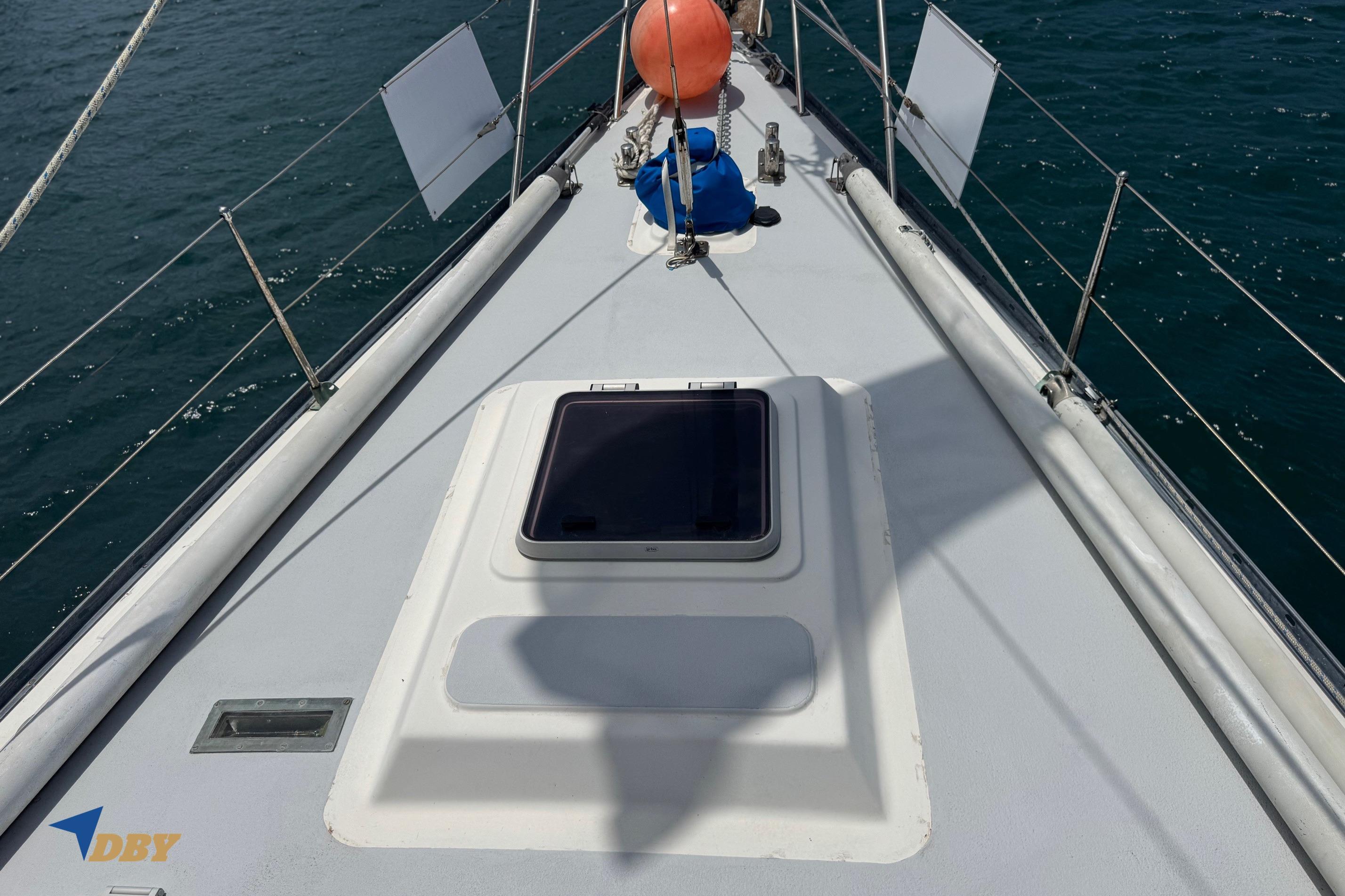 Bowman 47 sailboat deck, 1987 model, with ocean view and safety equipment.
