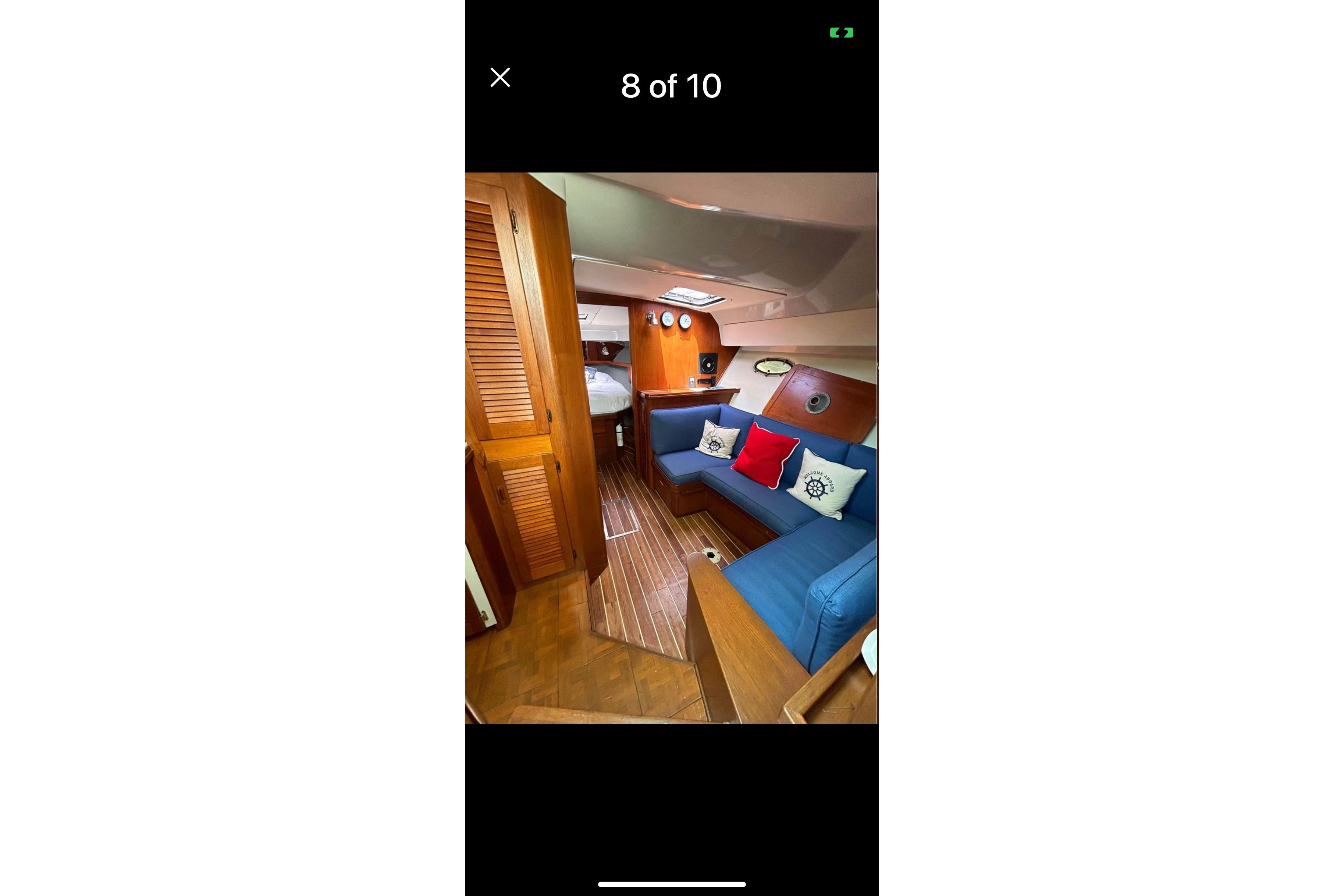 Interior of a 1987 Tiara 3600 yacht with blue seating and nautical decor.