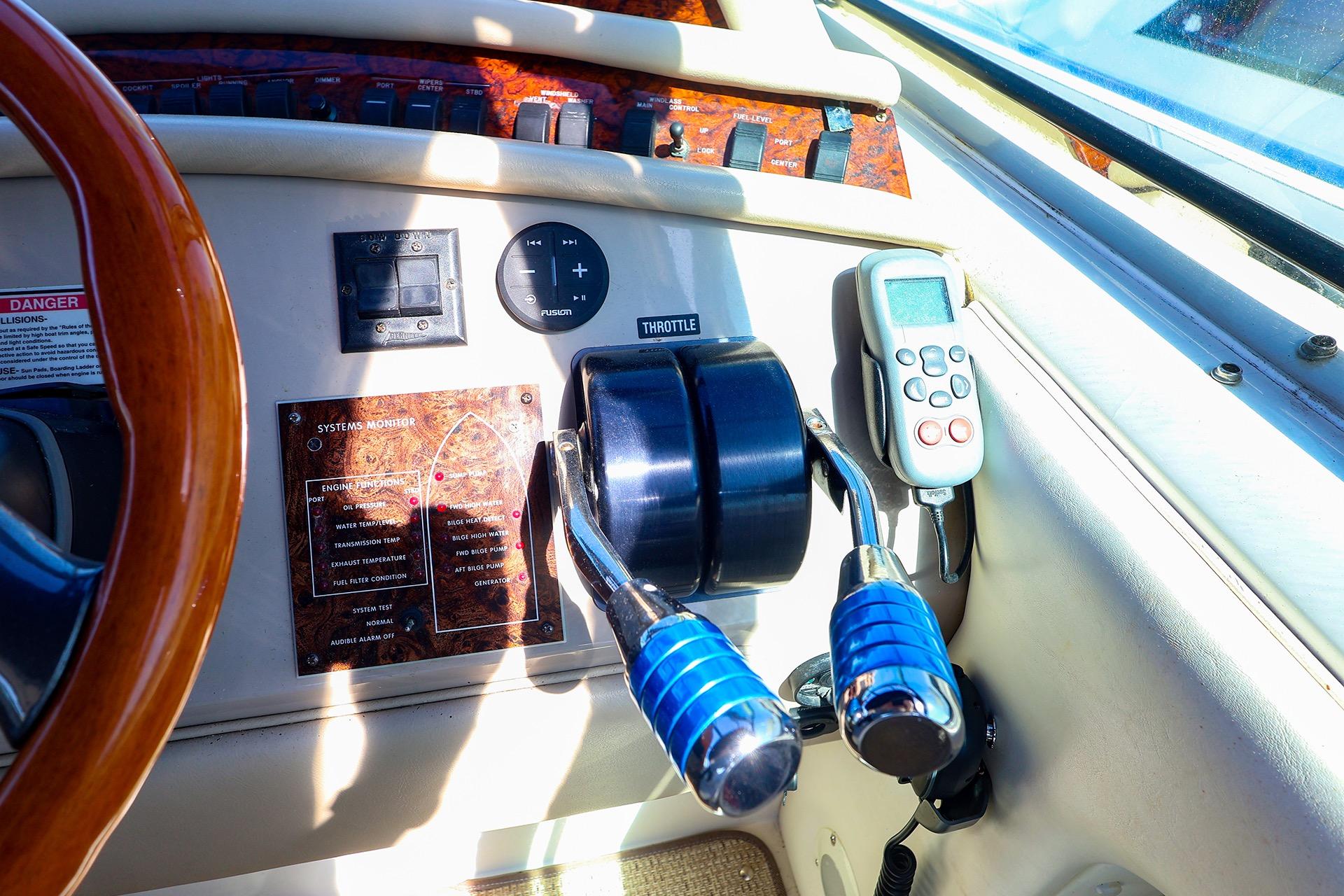 Control panel of a 1998 Sea Ray 500 Sundancer yacht with throttle and system monitor.