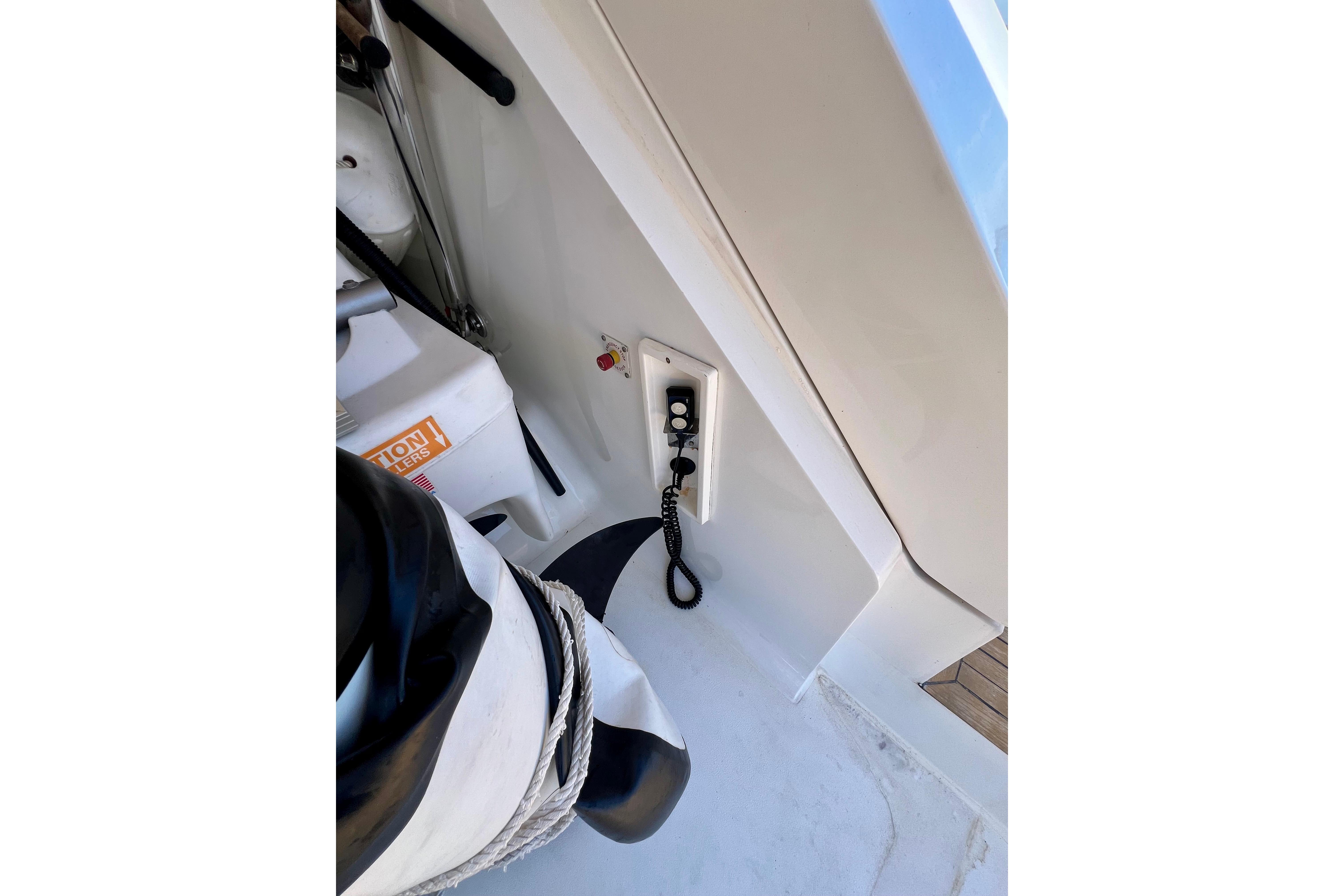 Control panel on 2010 Princess V78 yacht deck with coiled cable and safety equipment.