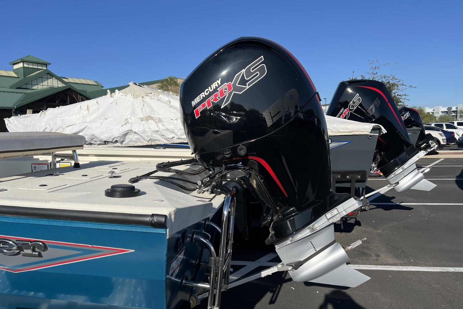 2024 Ranger RB200 boat with Mercury Pro XS outboard motors in a parking lot.