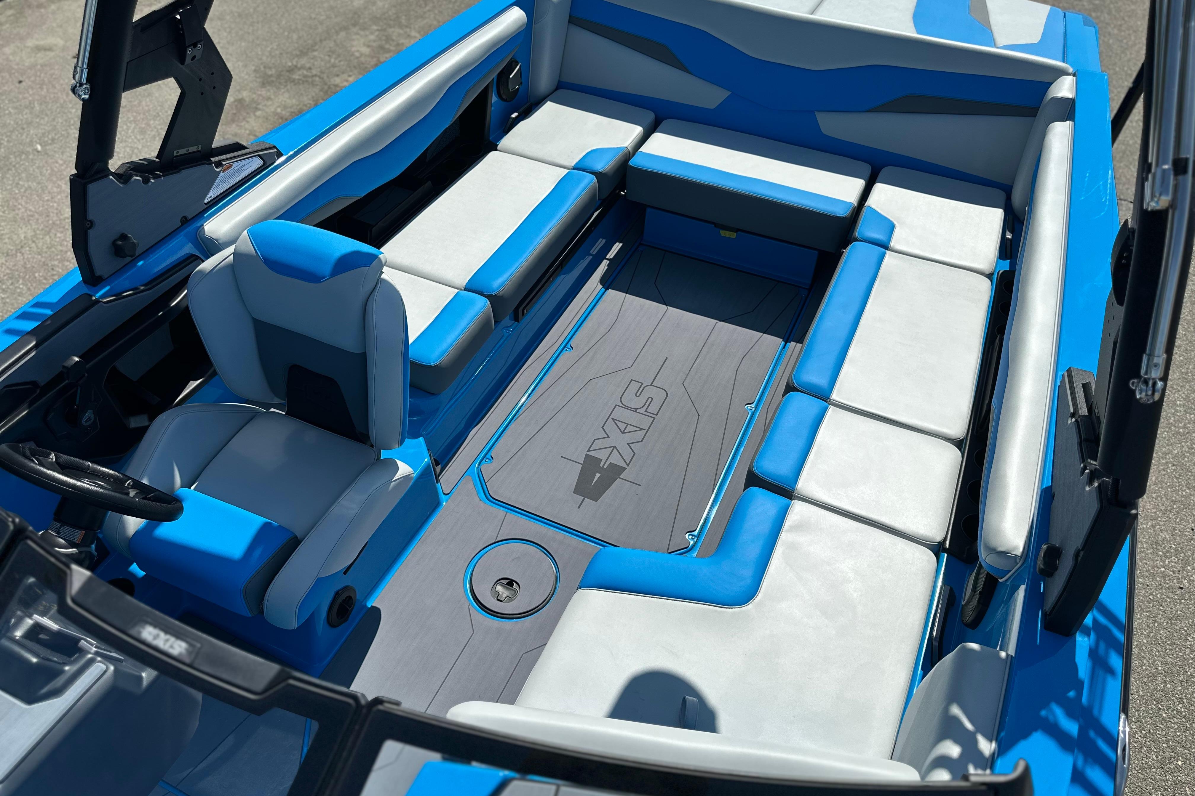 2026 Axis T235 boat interior with blue and gray seating, showcasing modern design.
