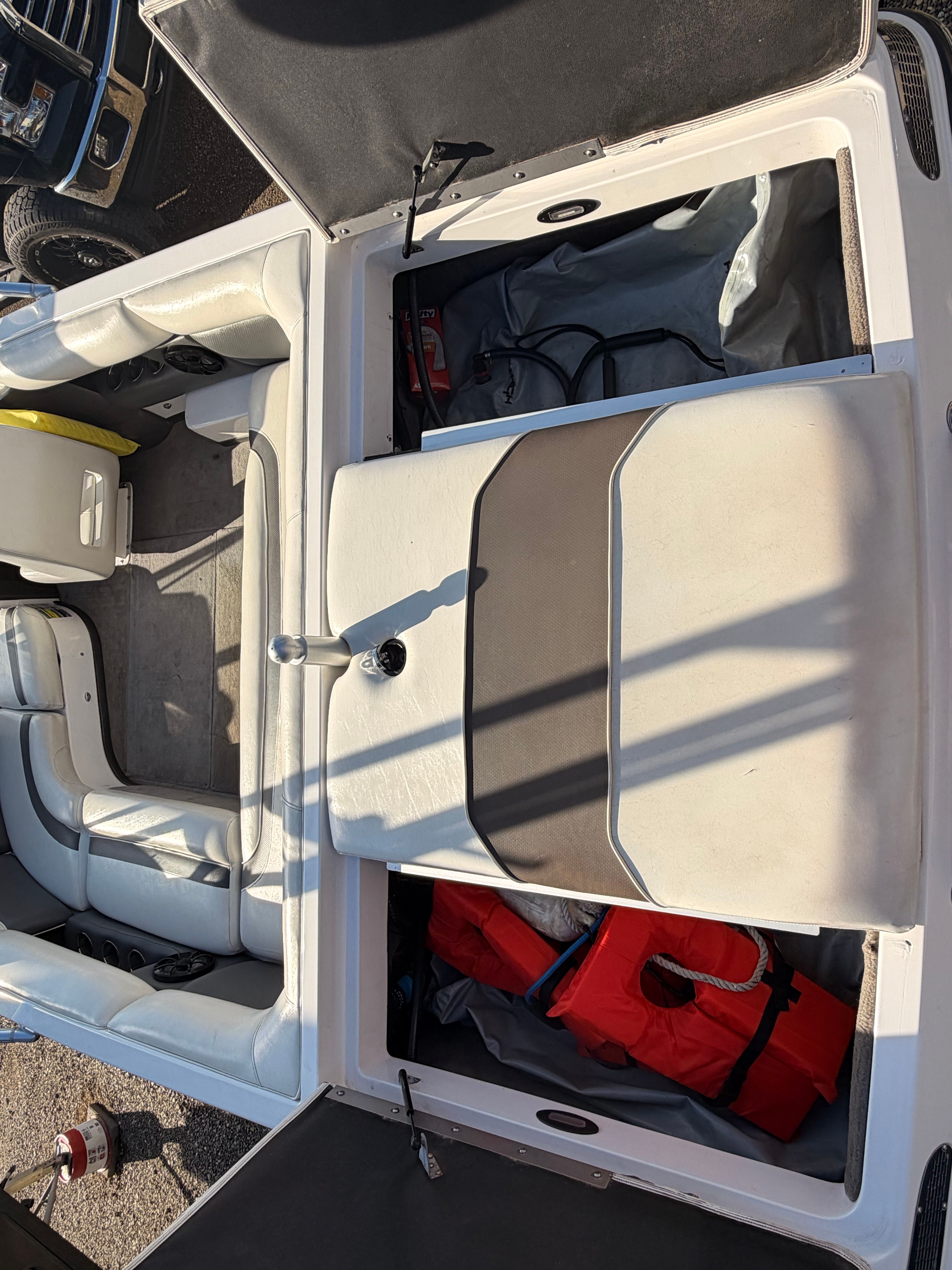 Interior of a 2004 Supra Launch SSV boat with storage and life jacket.