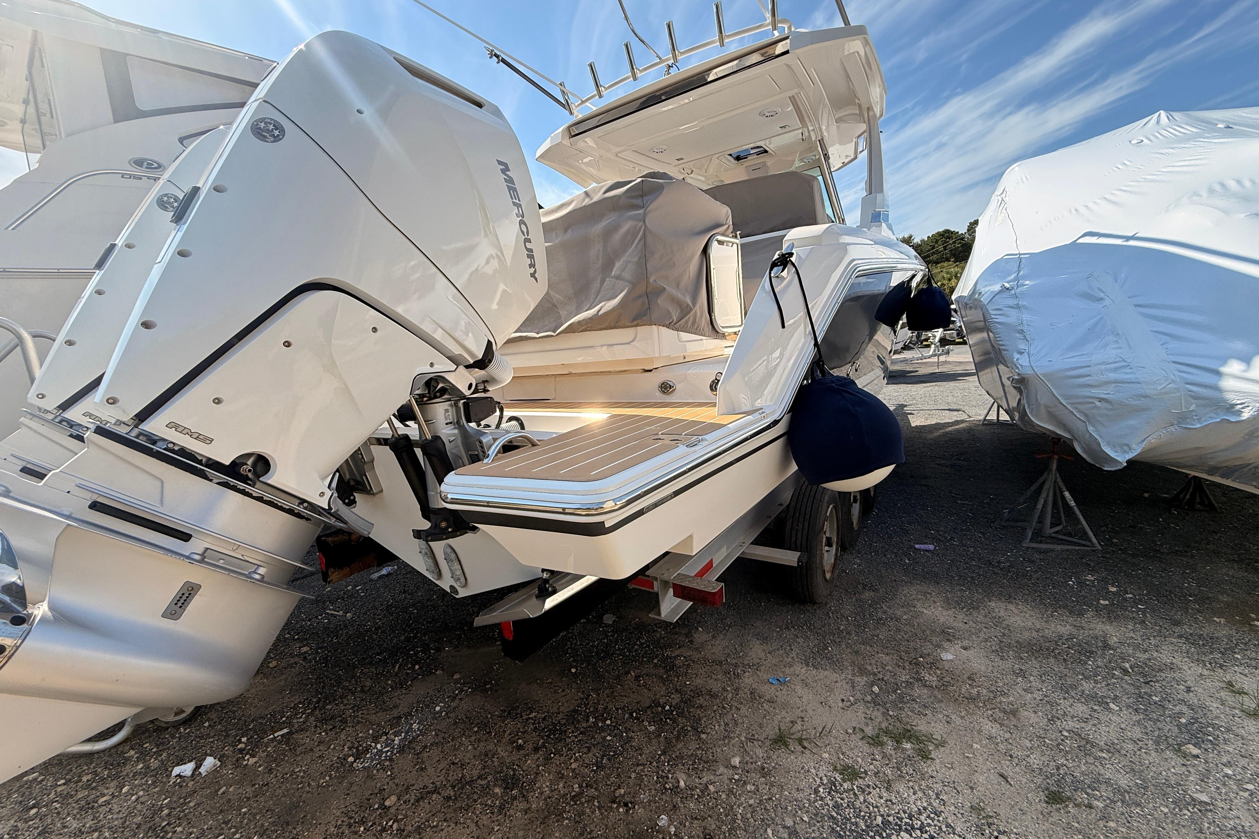 2024 Tiara Yachts 34 LS with Mercury outboard engines, docked outdoors under clear skies.