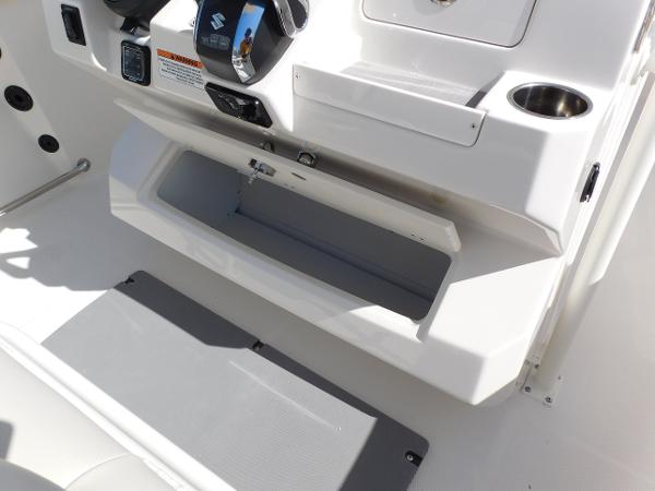 2024 Sailfish 242 CC boat console with open storage compartment.