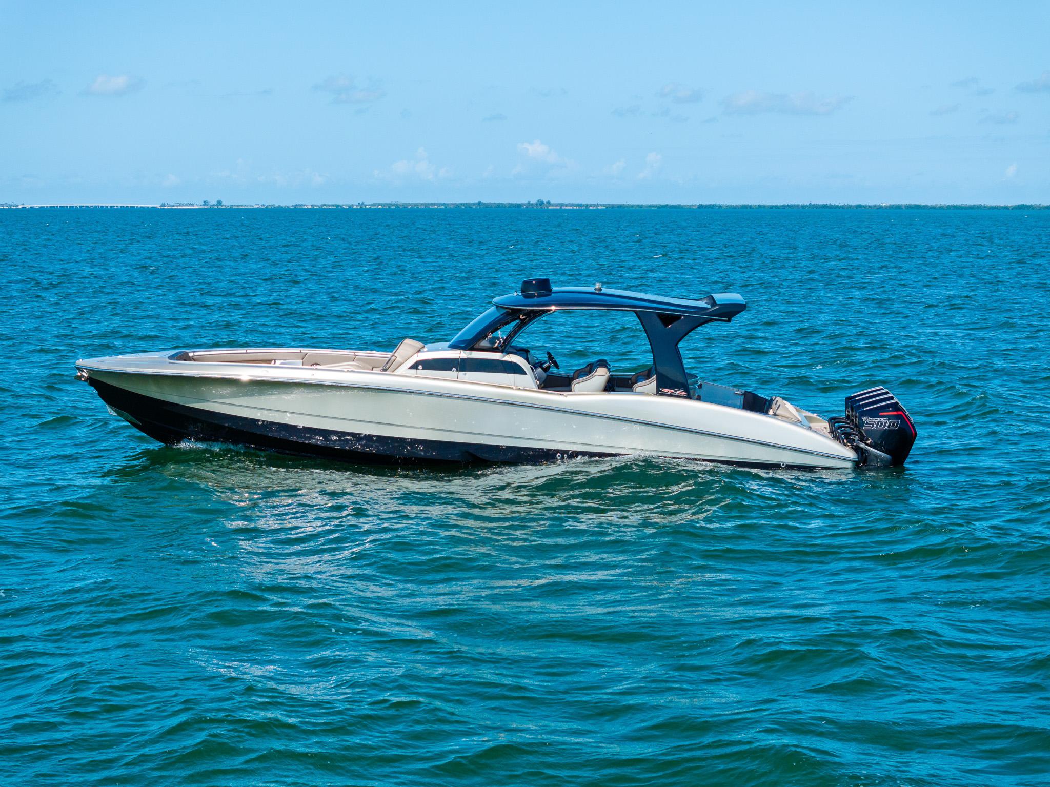 2021 MTI V42 boat on open water under clear blue sky.