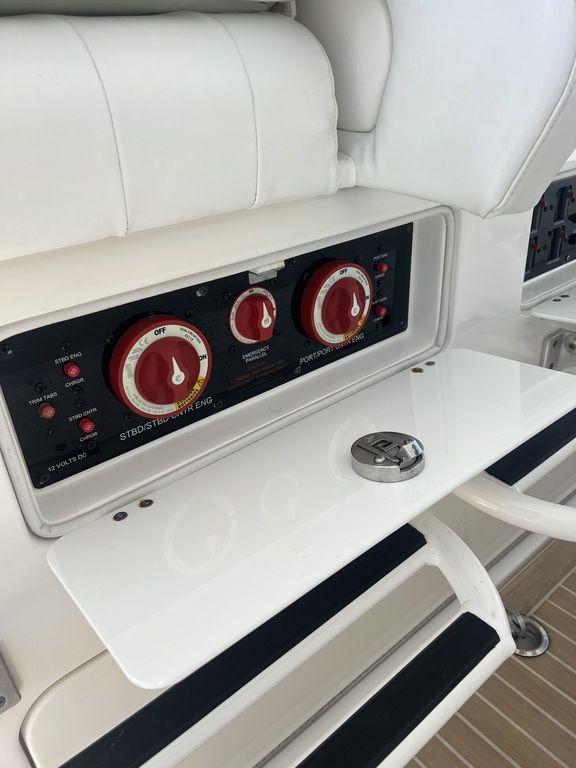 Control panel on a 2021 Regulator 41 boat with red dials and white seating.