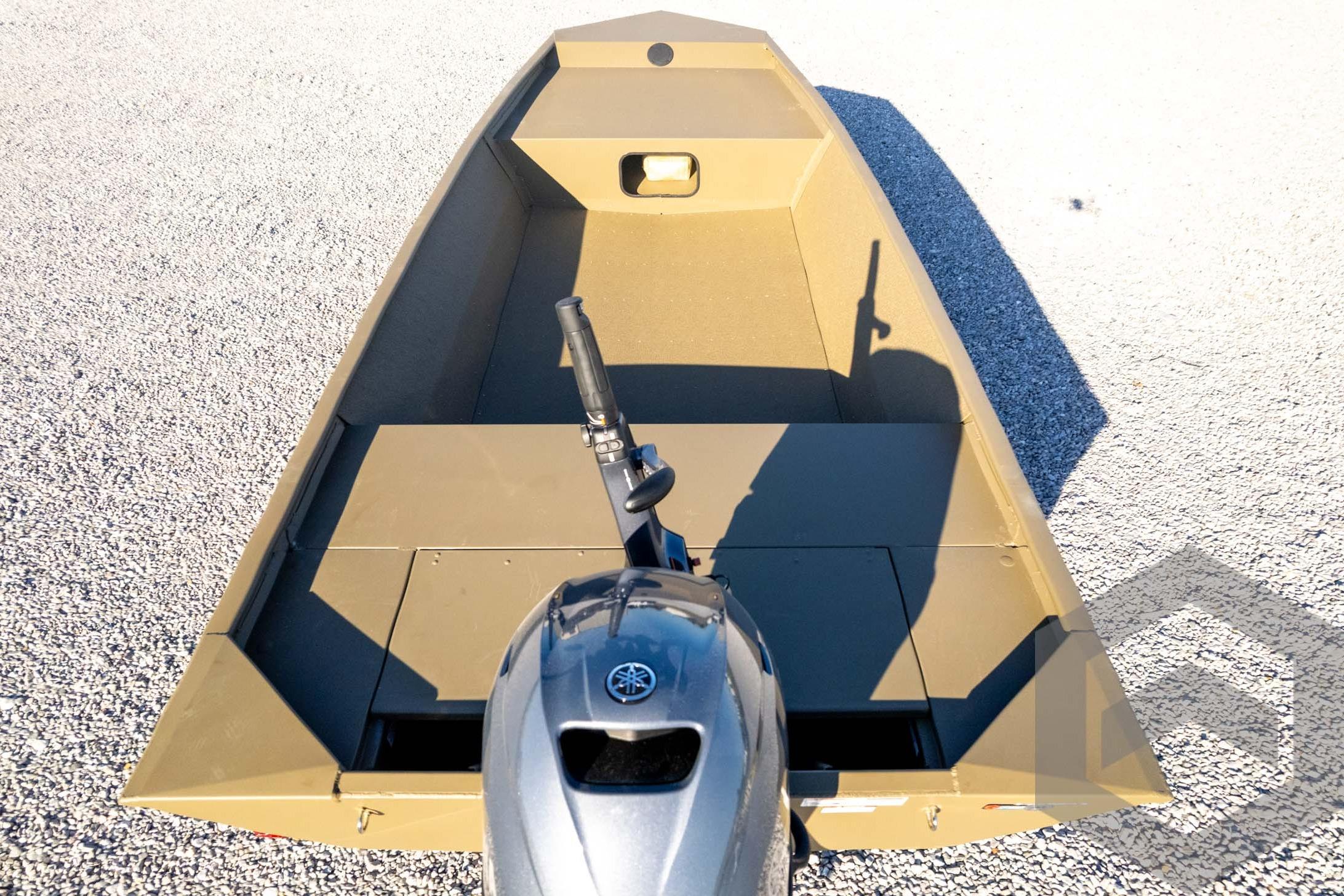 2026 G3 1652 VBW boat with outboard motor on gravel surface.
