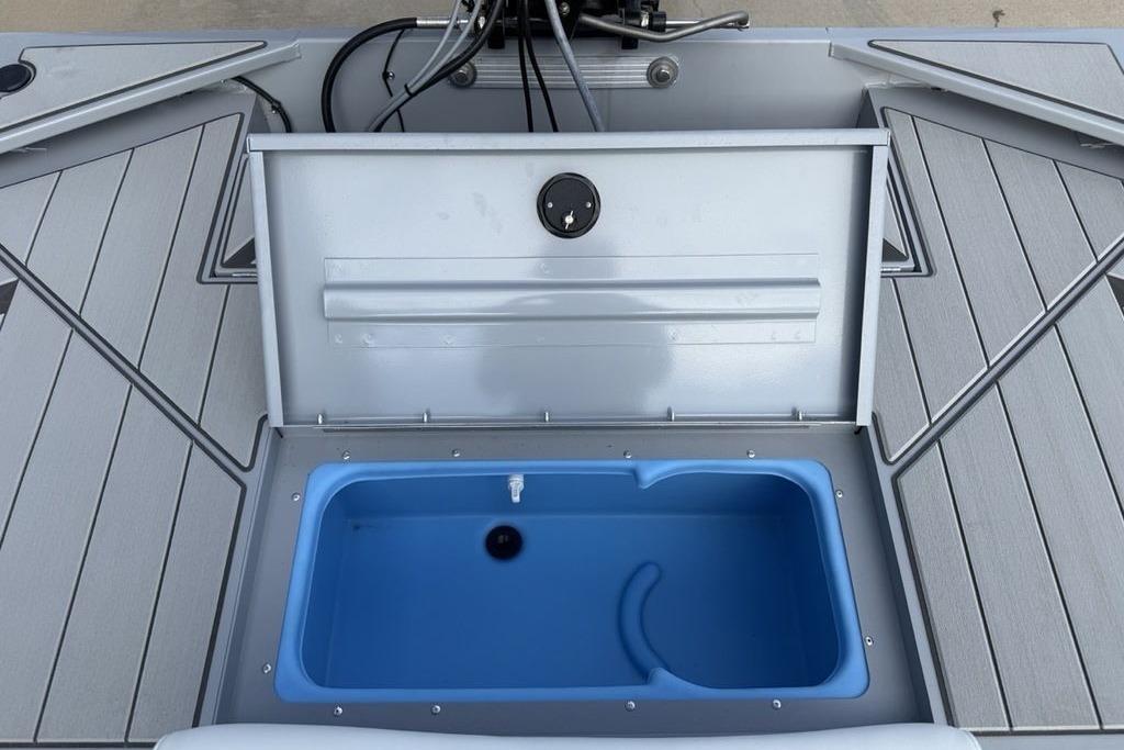 2026 Tracker Bass Tracker Classic CC boat with open storage compartment and blue interior.
