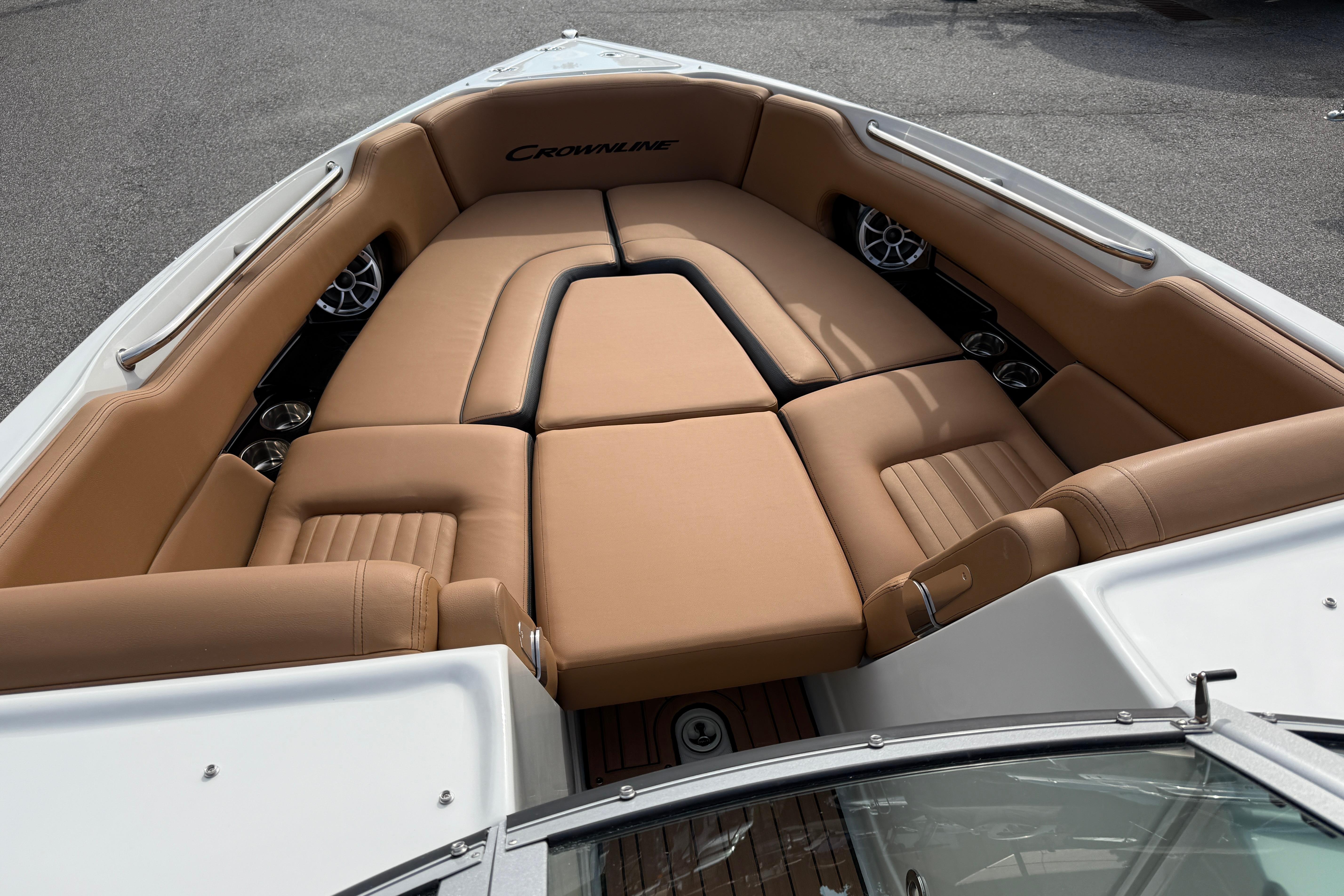 2026 Crownline 298 SS boat interior with tan leather seating and stainless steel accents.