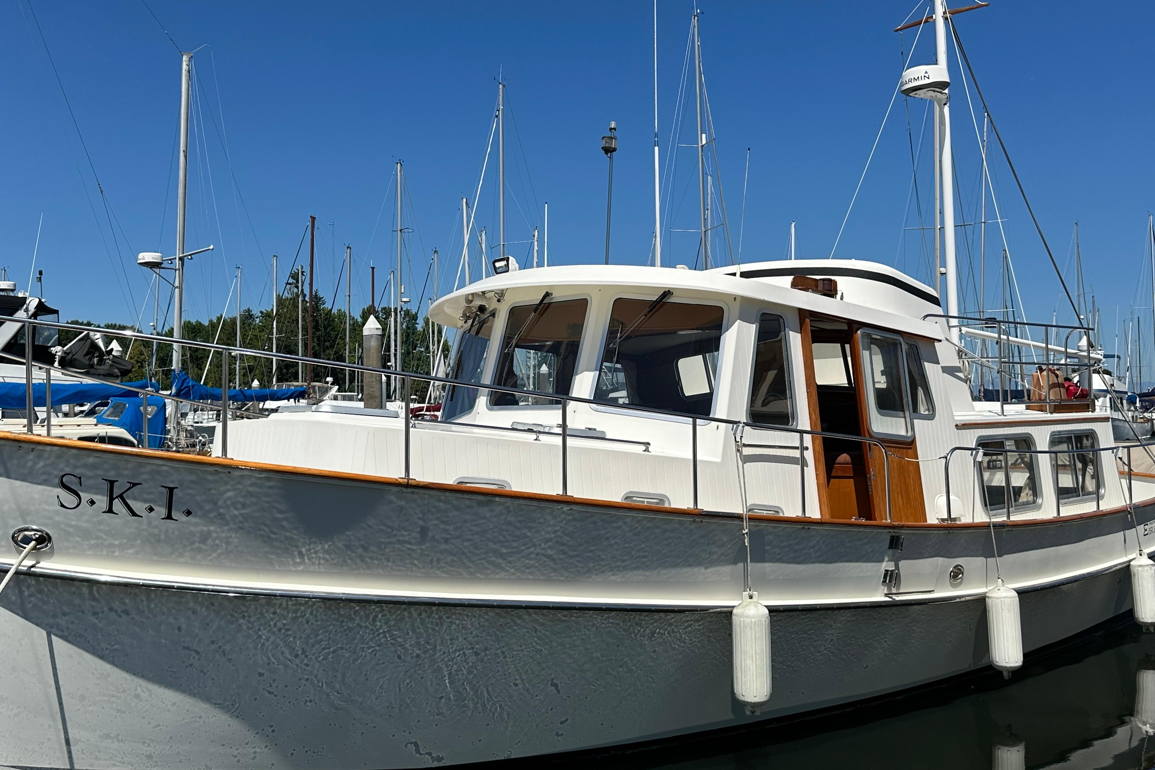 2000 Eagle 40 Pilothouse Trawler docked at marina under clear blue sky.