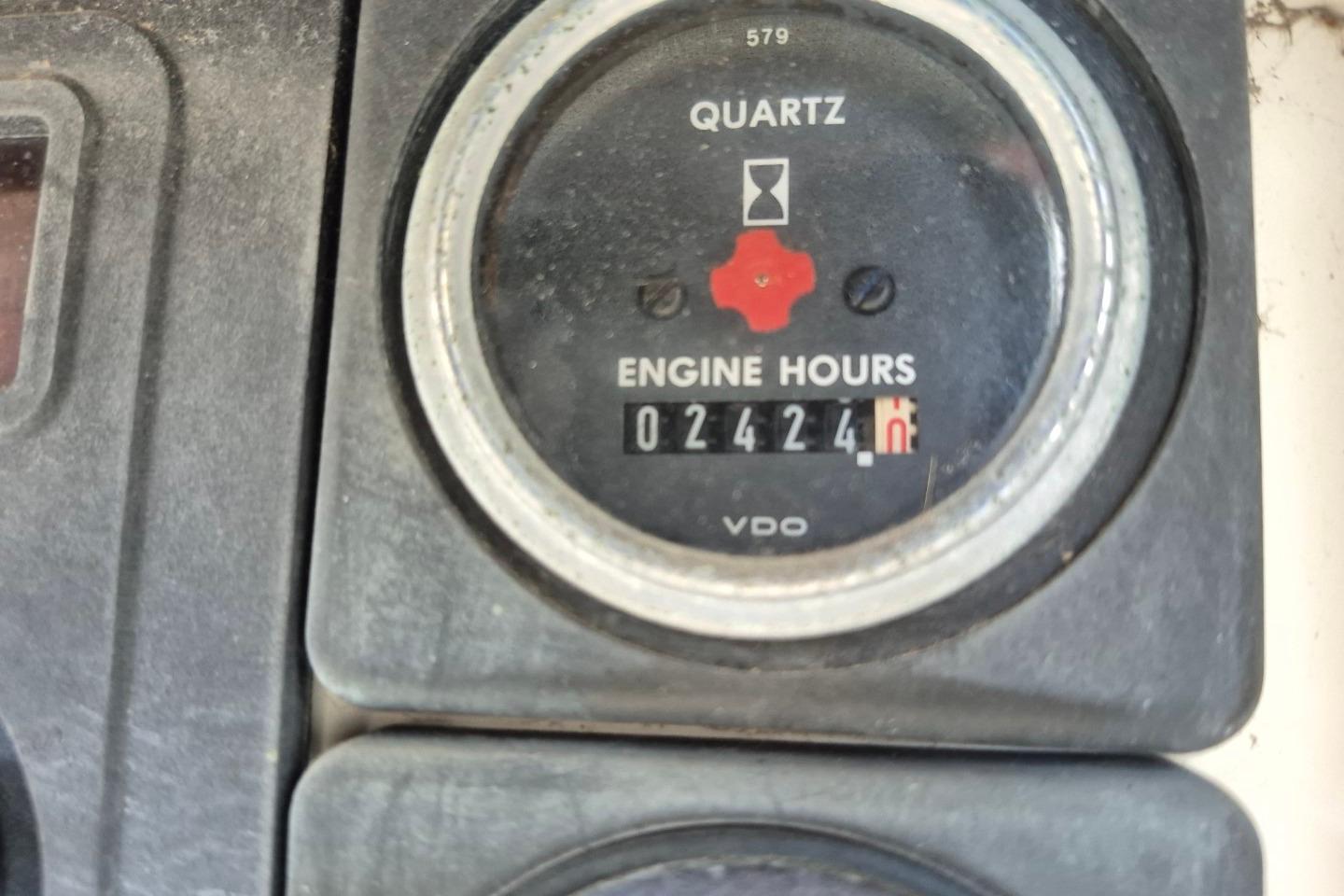 Close-up of a 1987 Morgan 384 engine hour meter displaying 2424 hours.
