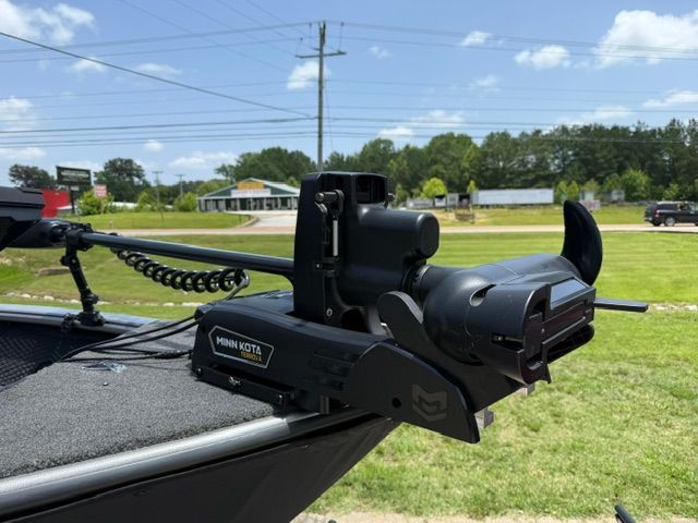 A Minn Kota trolling motor is mounted on the bow of a Lund 2075 Impact XS boat.