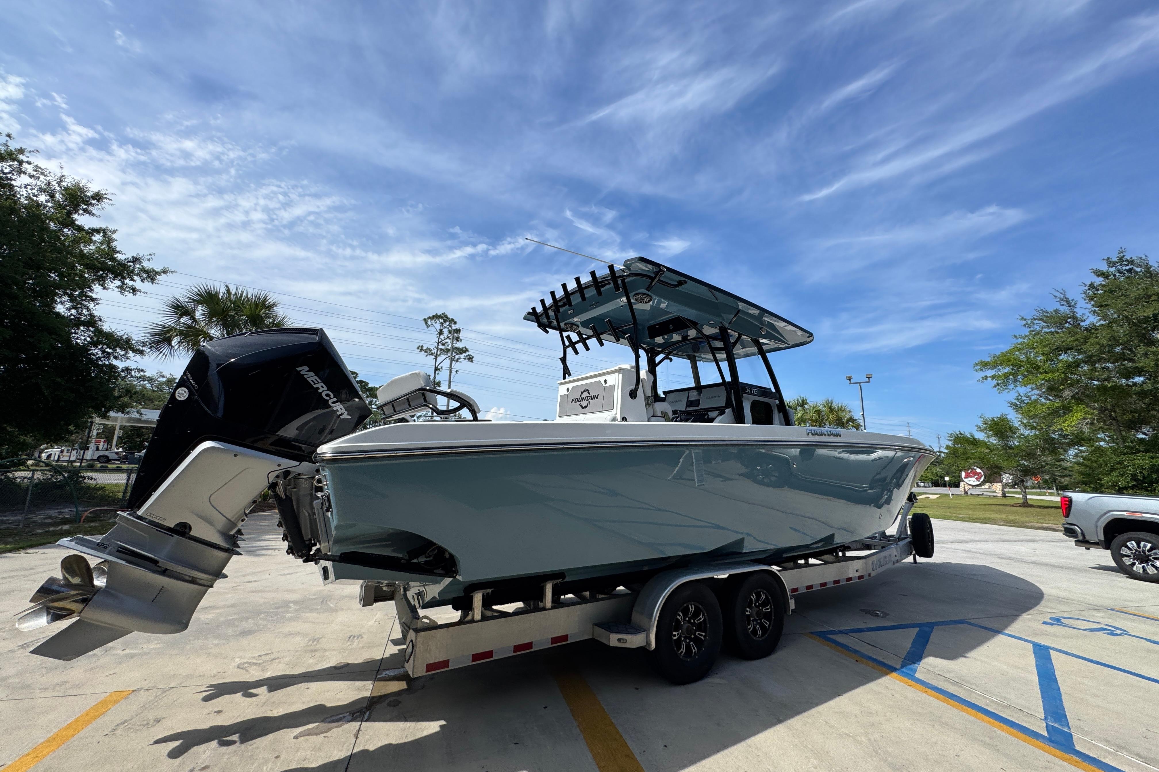 2023 Fountain 34 Tournament Edition boat on trailer, parked outdoors under blue sky.