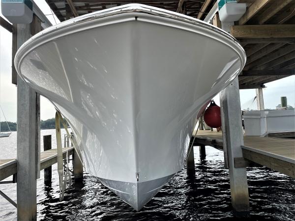 2020 Front Runner 39 Center Console boat docked under a wooden structure.
