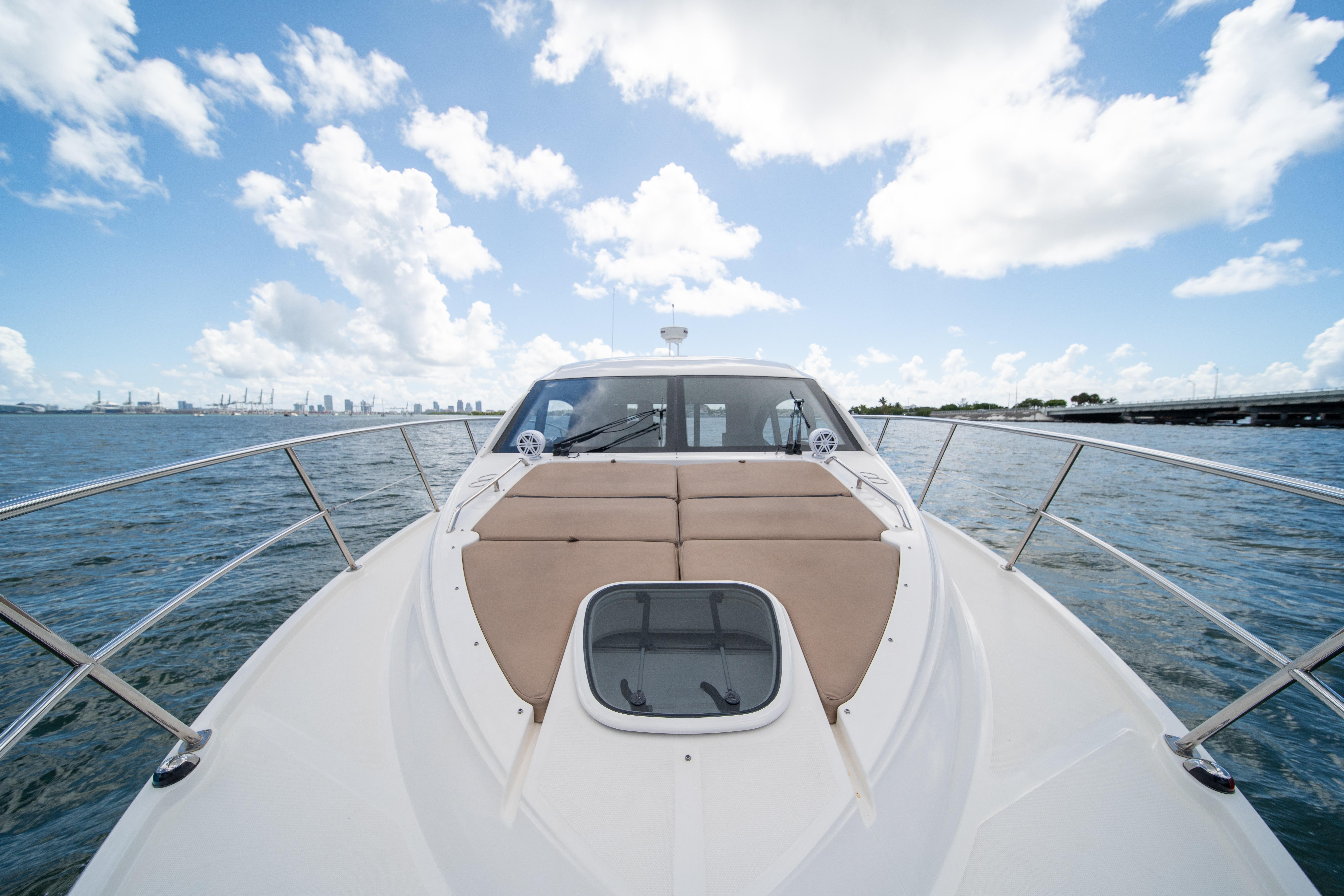 2016 Sea Ray 400 Sundancer yacht on open water under a bright blue sky.