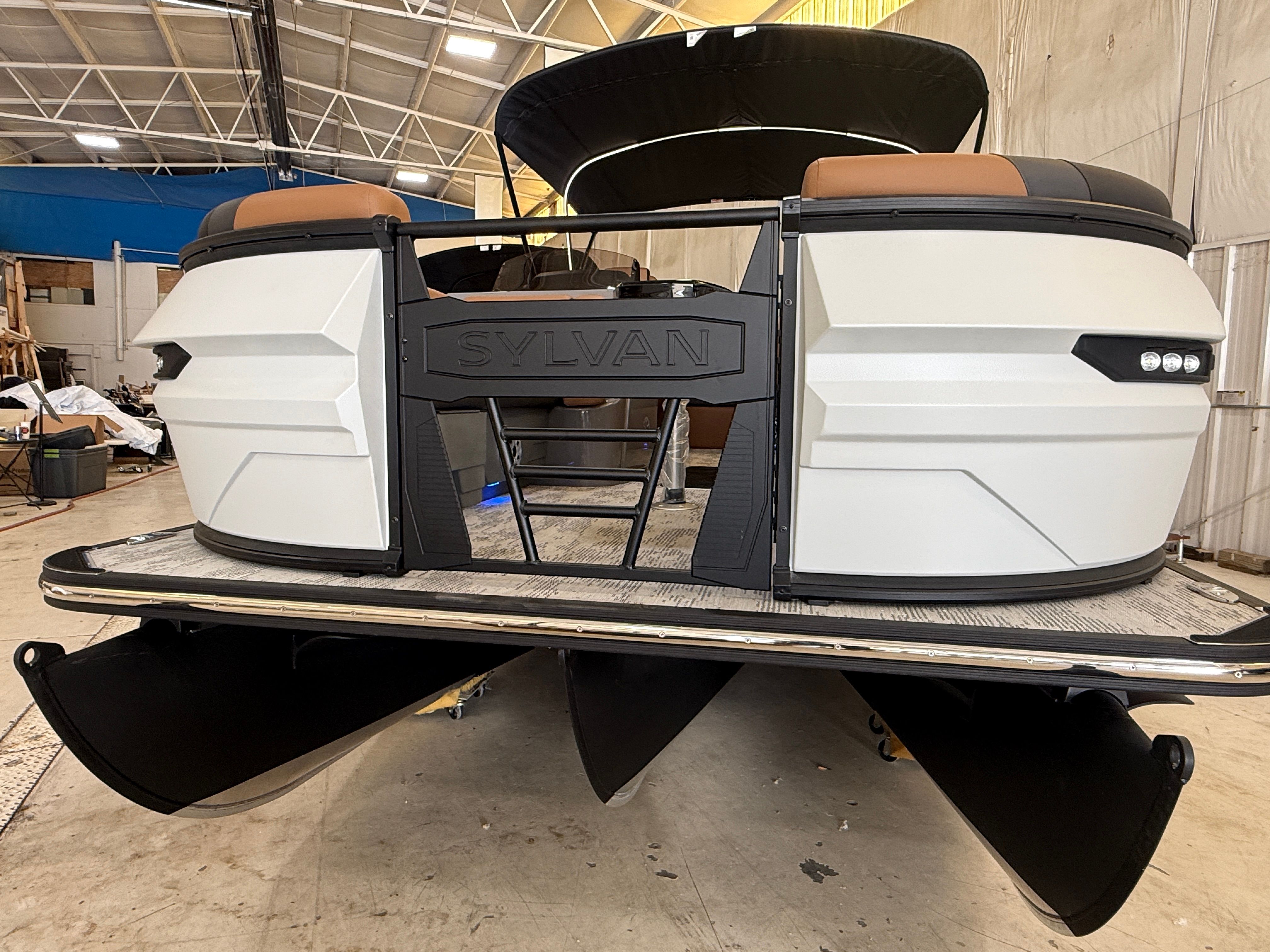 A 2026 Sylvan L3 ULZ DH pontoon boat in a warehouse.