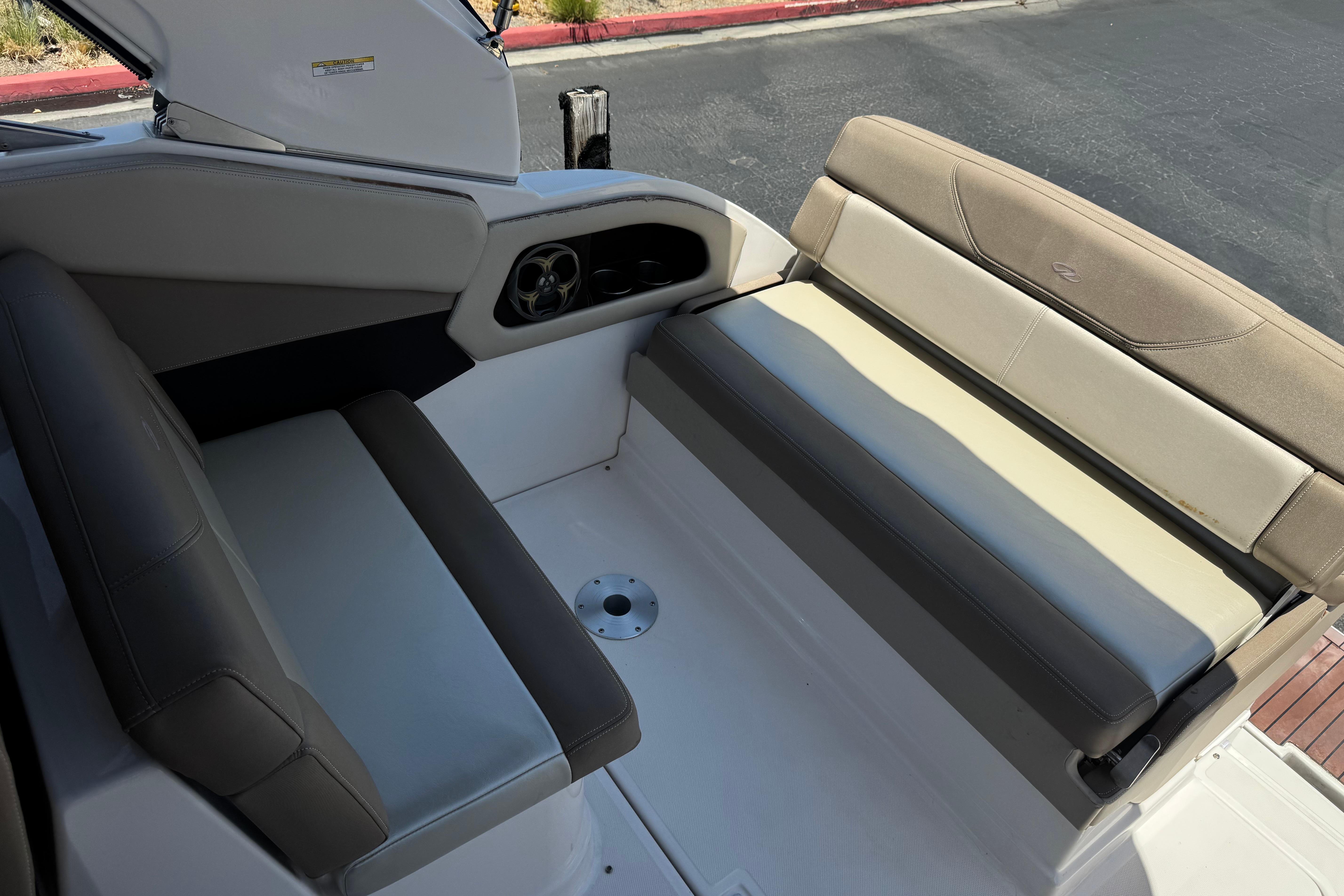 Interior seating of a 2013 Regal 28 Express boat, featuring cushioned benches.