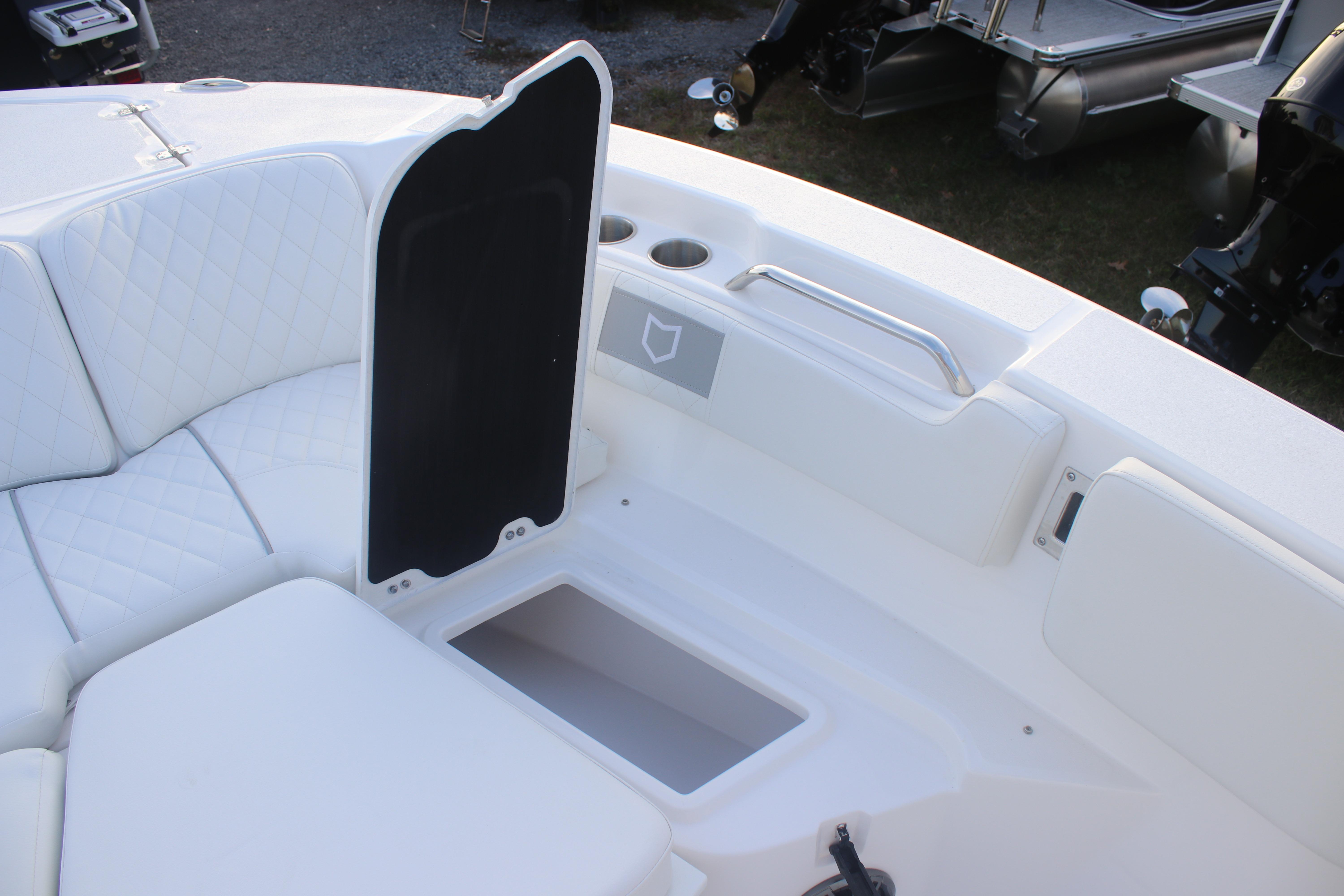 2026 Sea Fox 228 Commander boat interior with white seating and storage compartment.