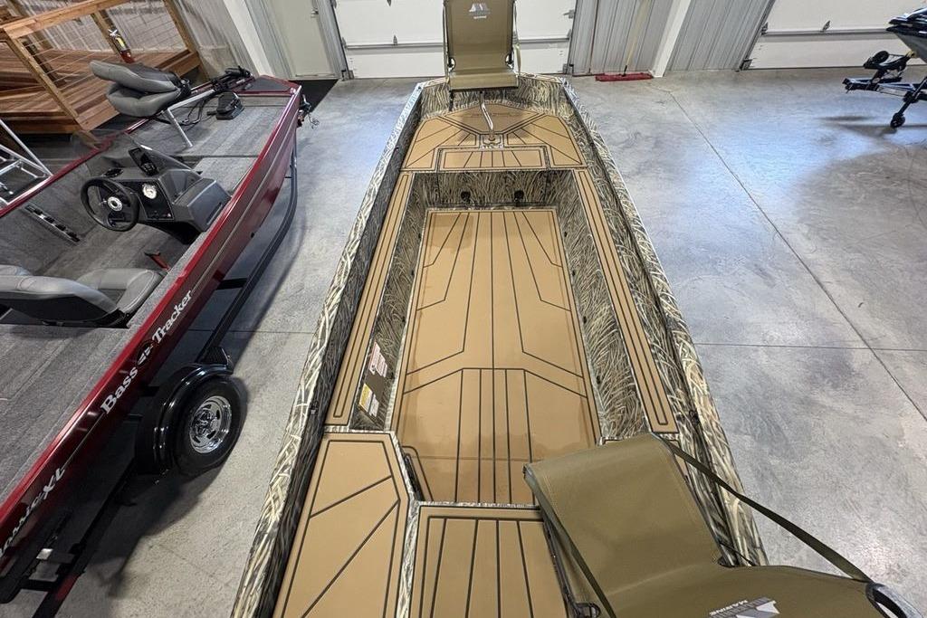 2026 Tracker Grizzly 1650 T Prairie Wings Edition boat in a showroom.
