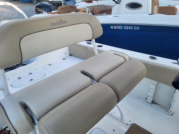 2021 NauticStar 2302 Legacy boat with beige seating and blue hull.