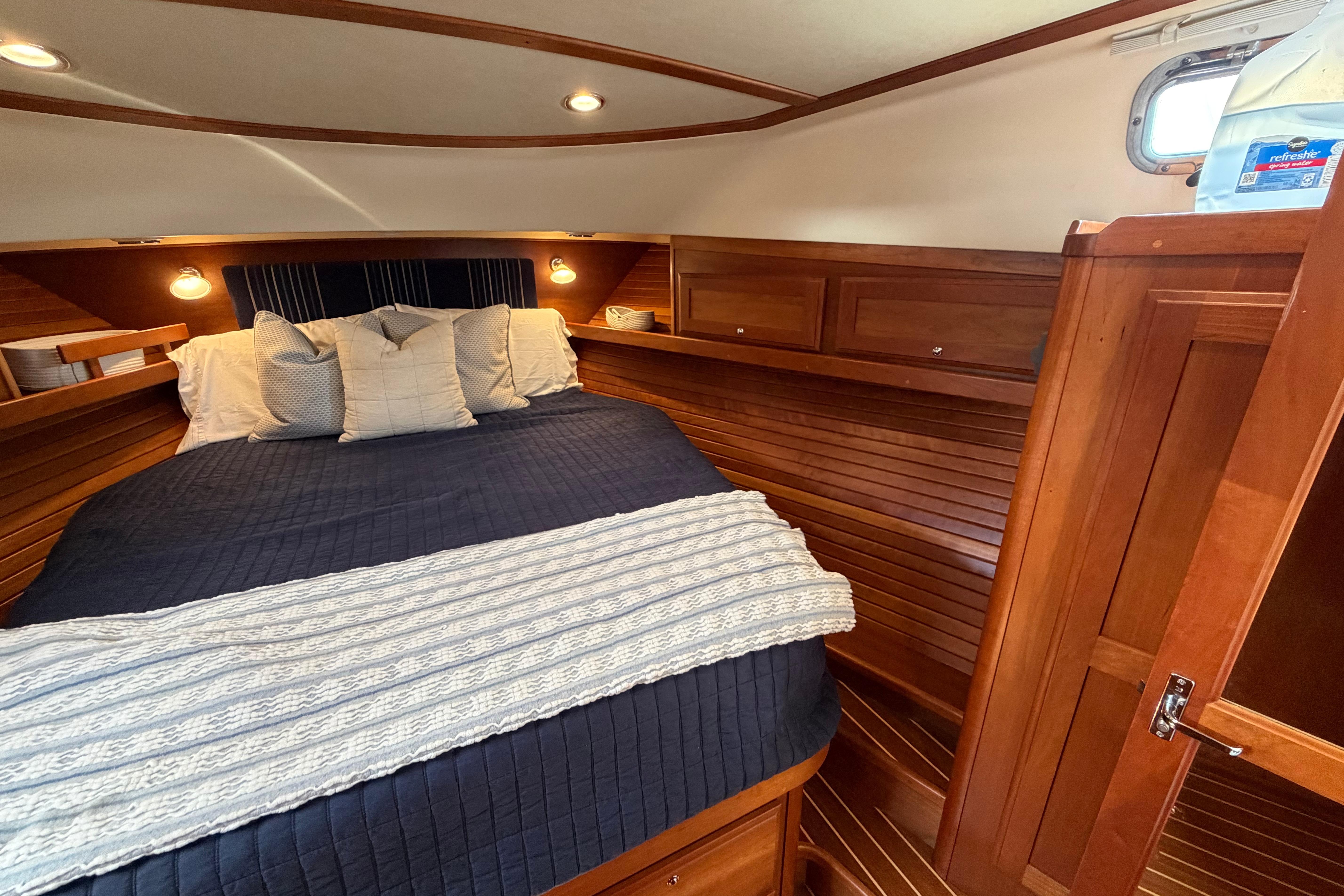 Luxurious cabin interior of 2015 Sabre 38 Salon Express yacht with cozy bedding.