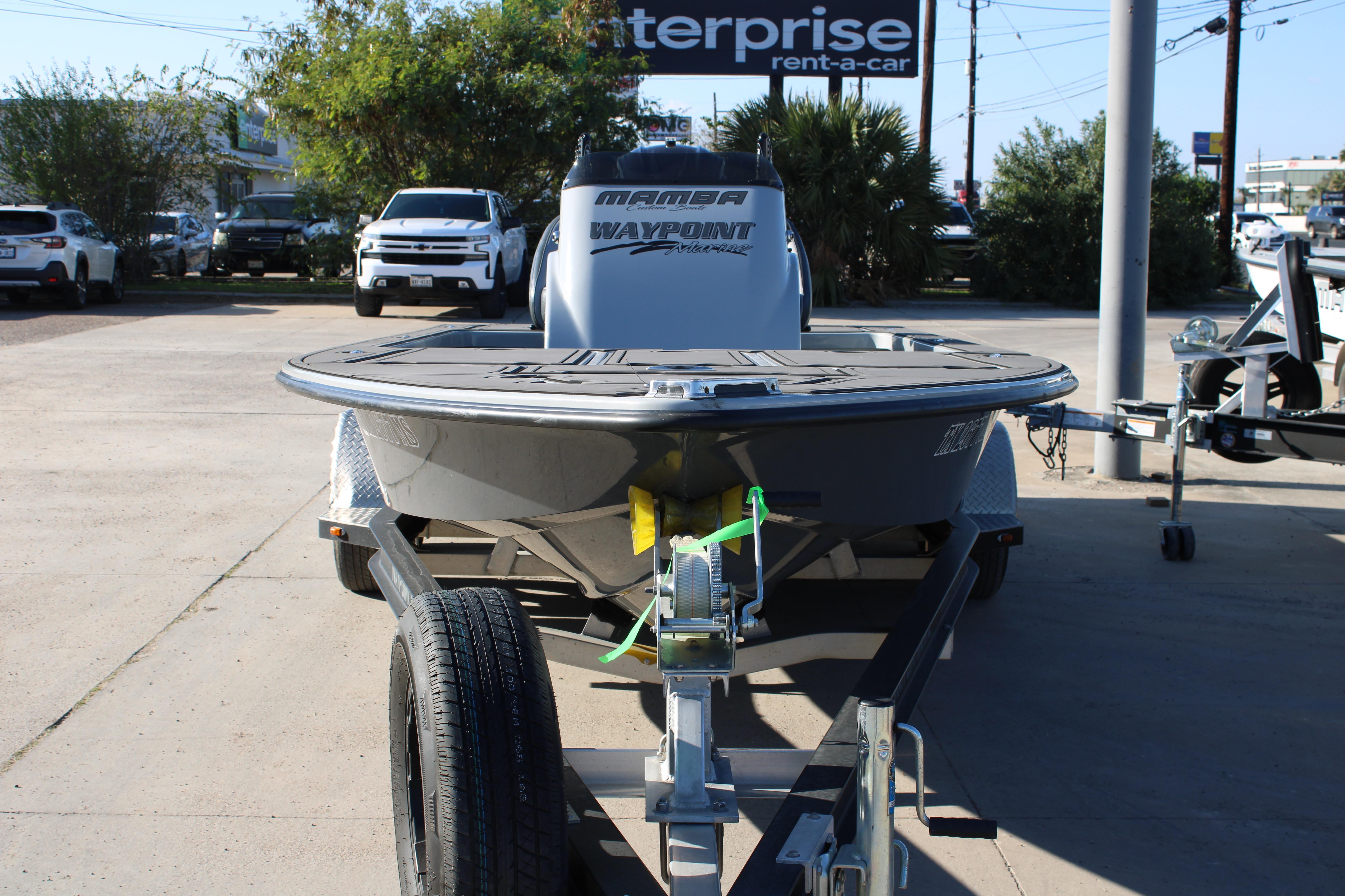 2025 Mamba 227VX boat on trailer at dealership parking lot.