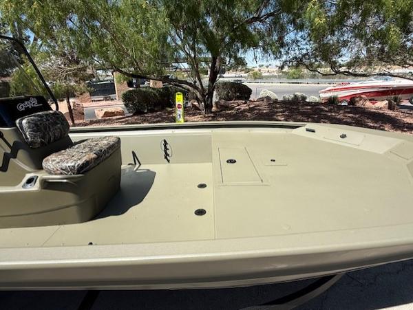 2025 Tracker Grizzly 1860 CC boat, spacious deck, camo seat, outdoor setting.