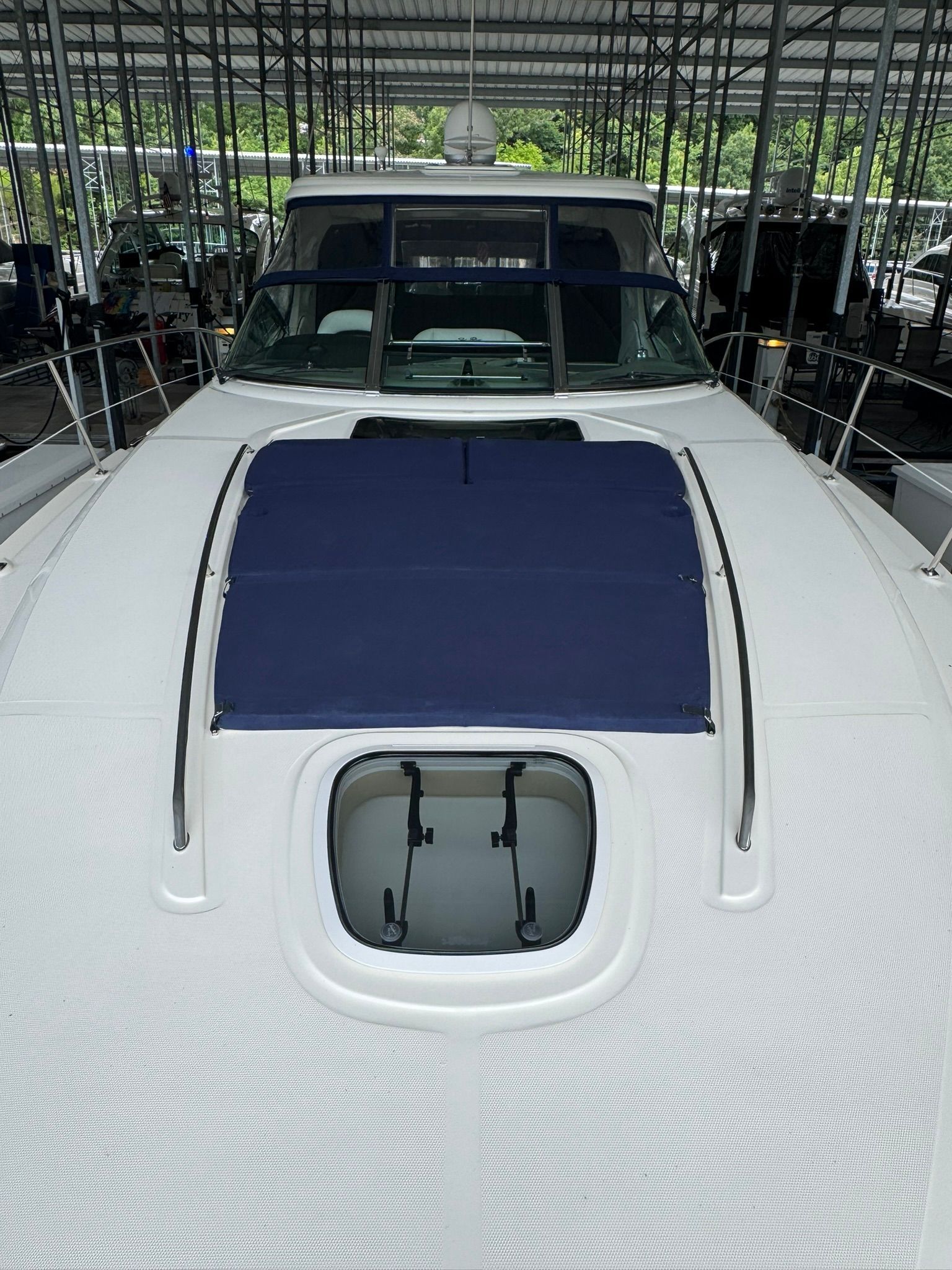 The 2007 Sea Ray 40 Sundancer is docked in a covered marina, featuring a blue sunshade.