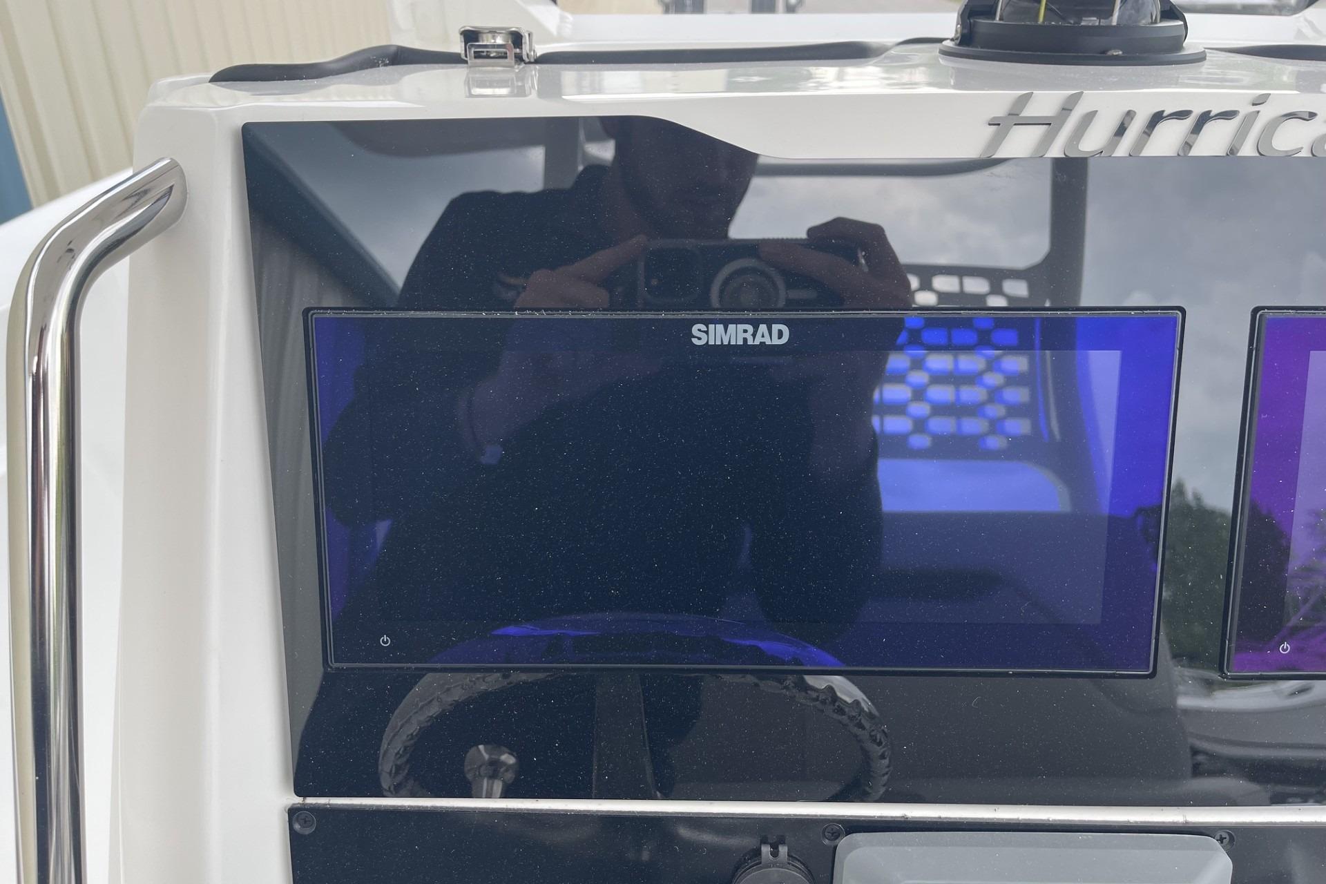 2026 Hurricane Center Console 24 OB dashboard with Simrad display screen.
