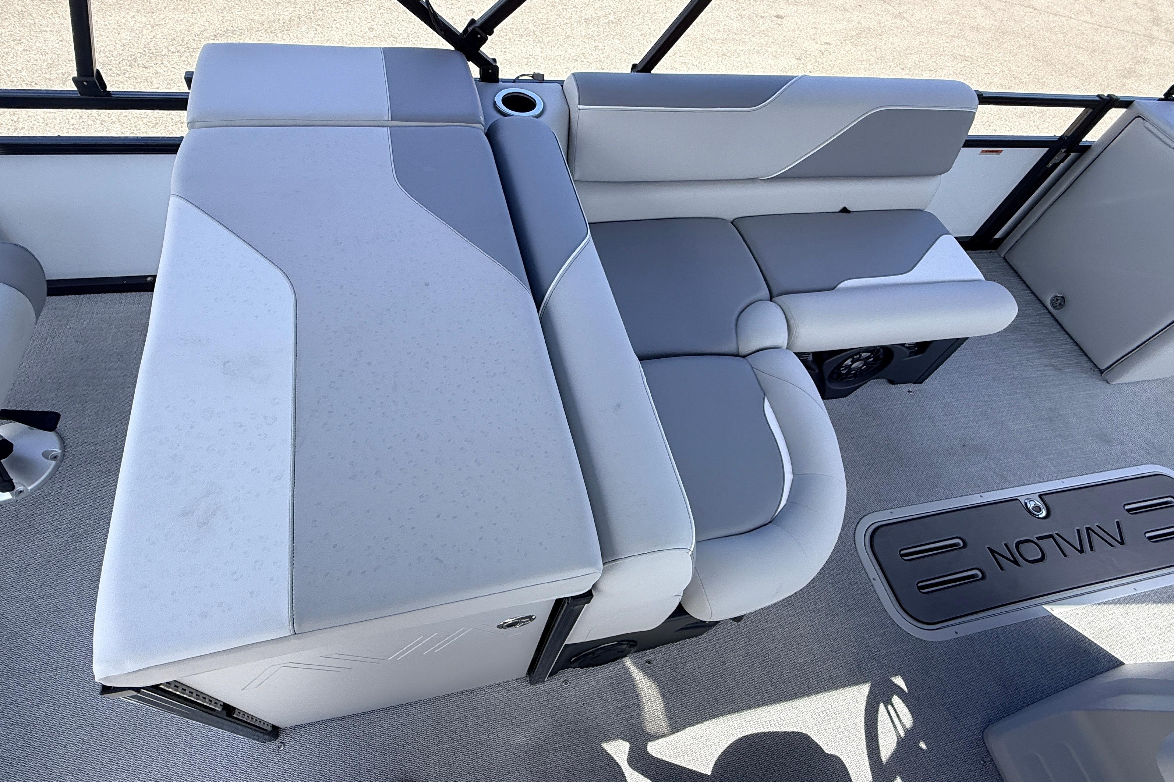 2026 Avalon 2385 Venture 85 Tri Toon boat interior with gray seating and cup holder.