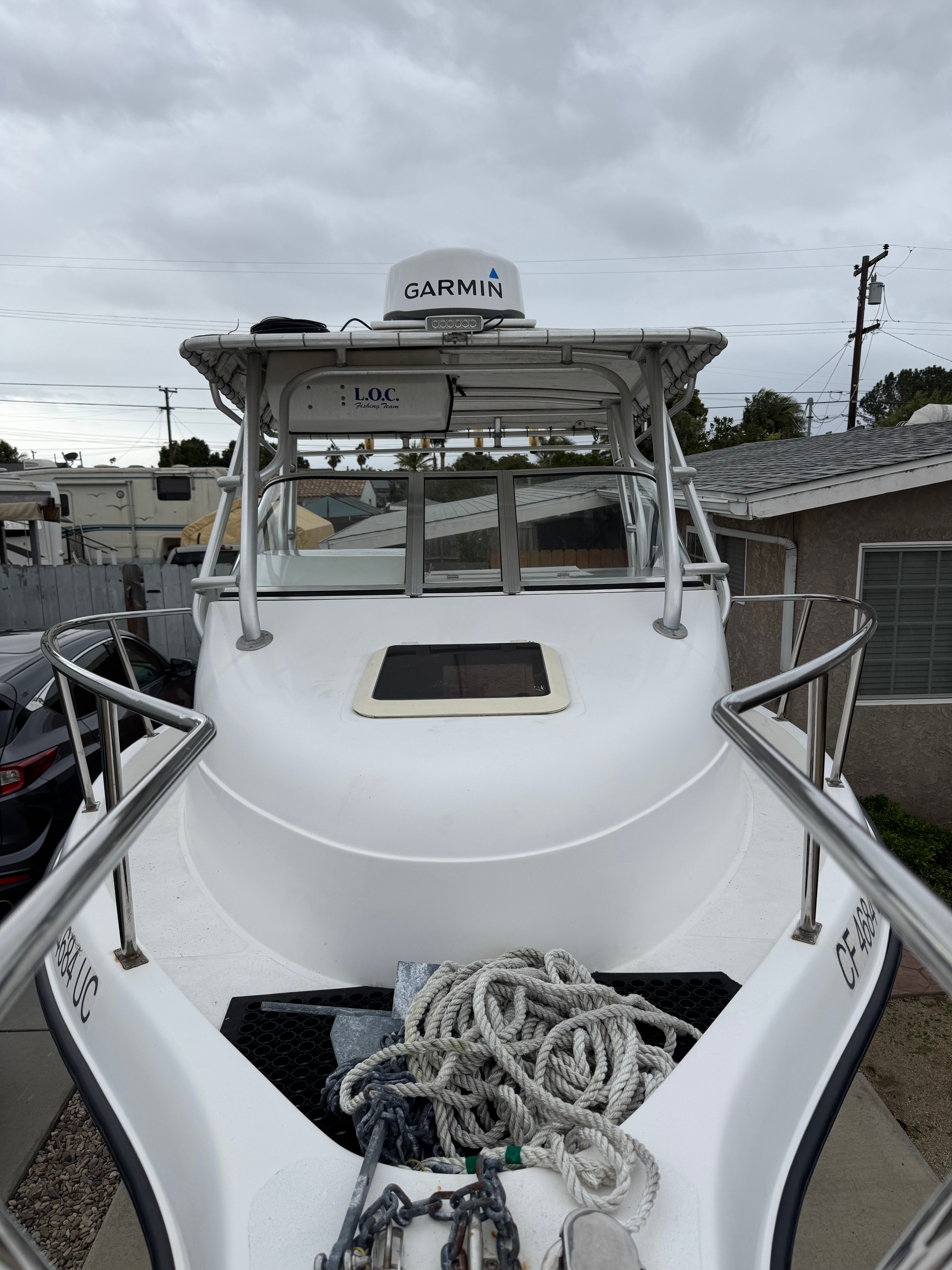 A 1999 Cobia Walkaround boat with a Garmin radar on the roof.