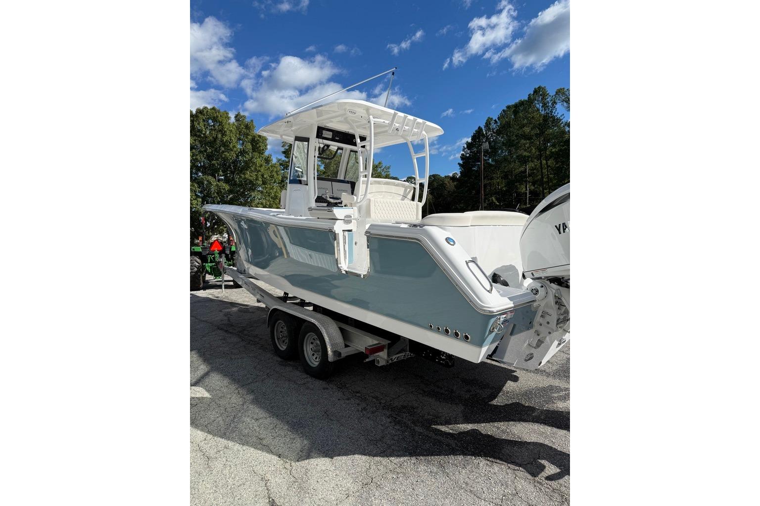 2026 Sea Hunt Ultra 285 Coffin Box boat on trailer under clear blue sky.