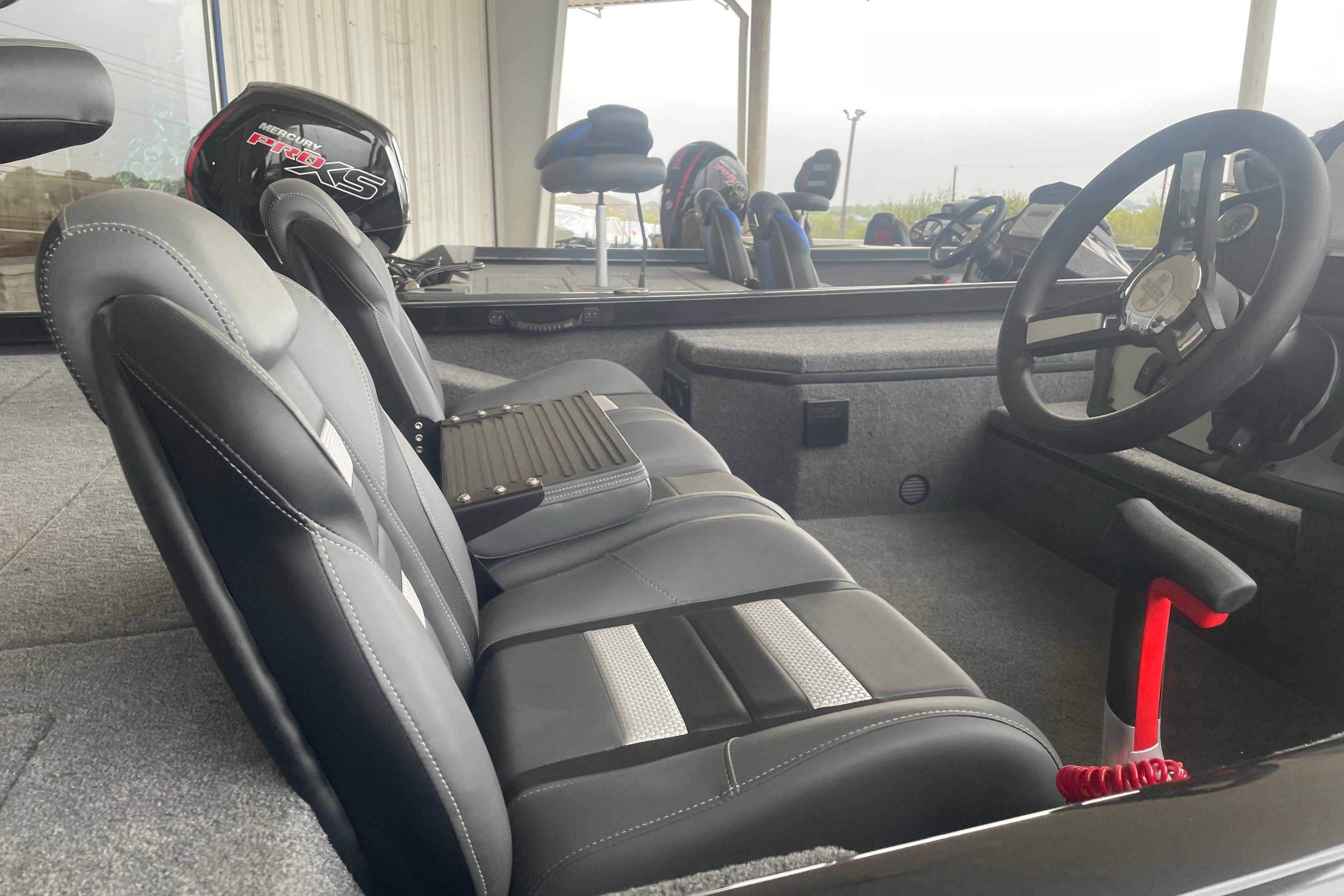2026 Ranger RT178 boat interior with steering wheel and seating, featuring a Mercury Pro XS engine.